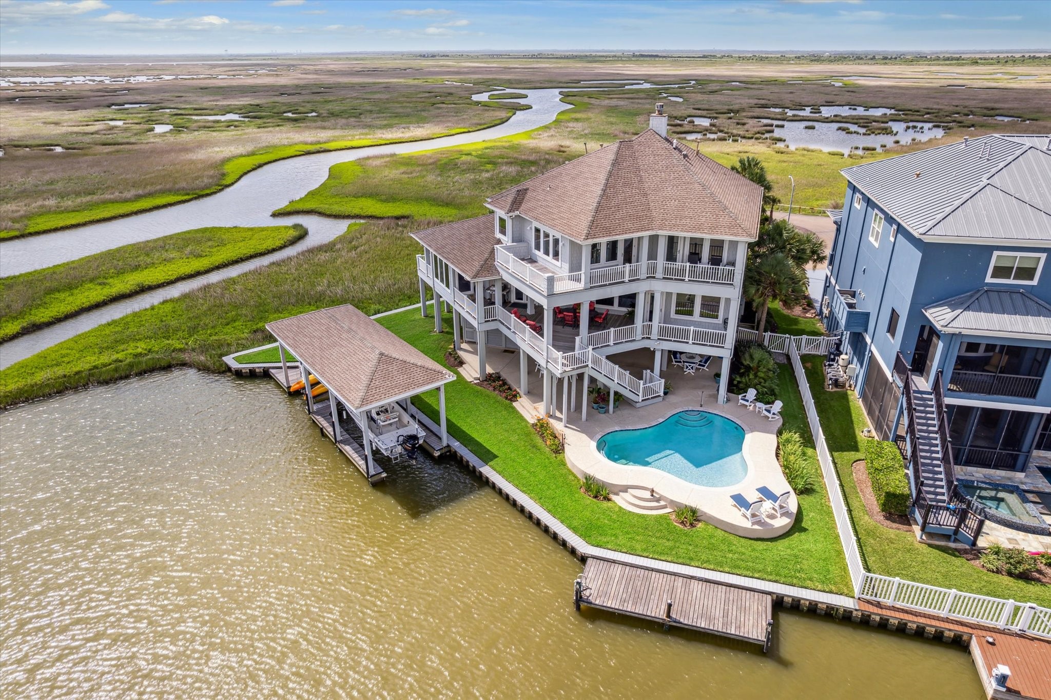 Designed for coastal living, the home blends indoor-outdoor space with covered patios, custom built pool with spray-deck surround and lower floor patio. Direct water accessperfect for boating, birding, and fishing right from your backyard