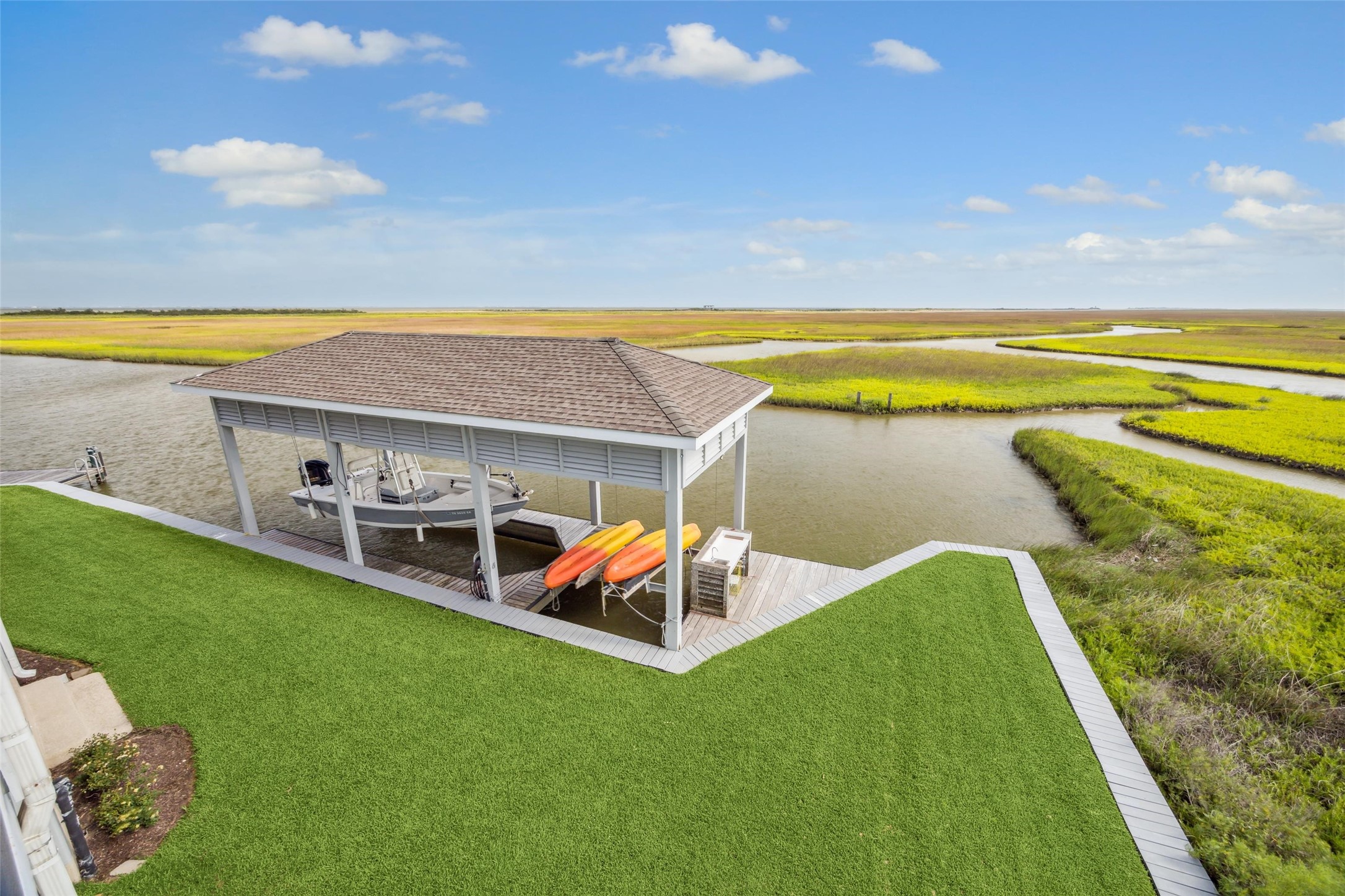 An exceptional 15x40 boathouse with two boat lifts, featuring new pier framing and premium IPE decking for lasting durability. Adjacent to the boathouse, an 8x20 fishing pier also finished in IPE decking includes an underwater fishing lightperfect for night fishingand a built-in cleaning station. With direct access to the Intracoastal Canal and West Galveston Bay, its a boaters and anglers dream setup