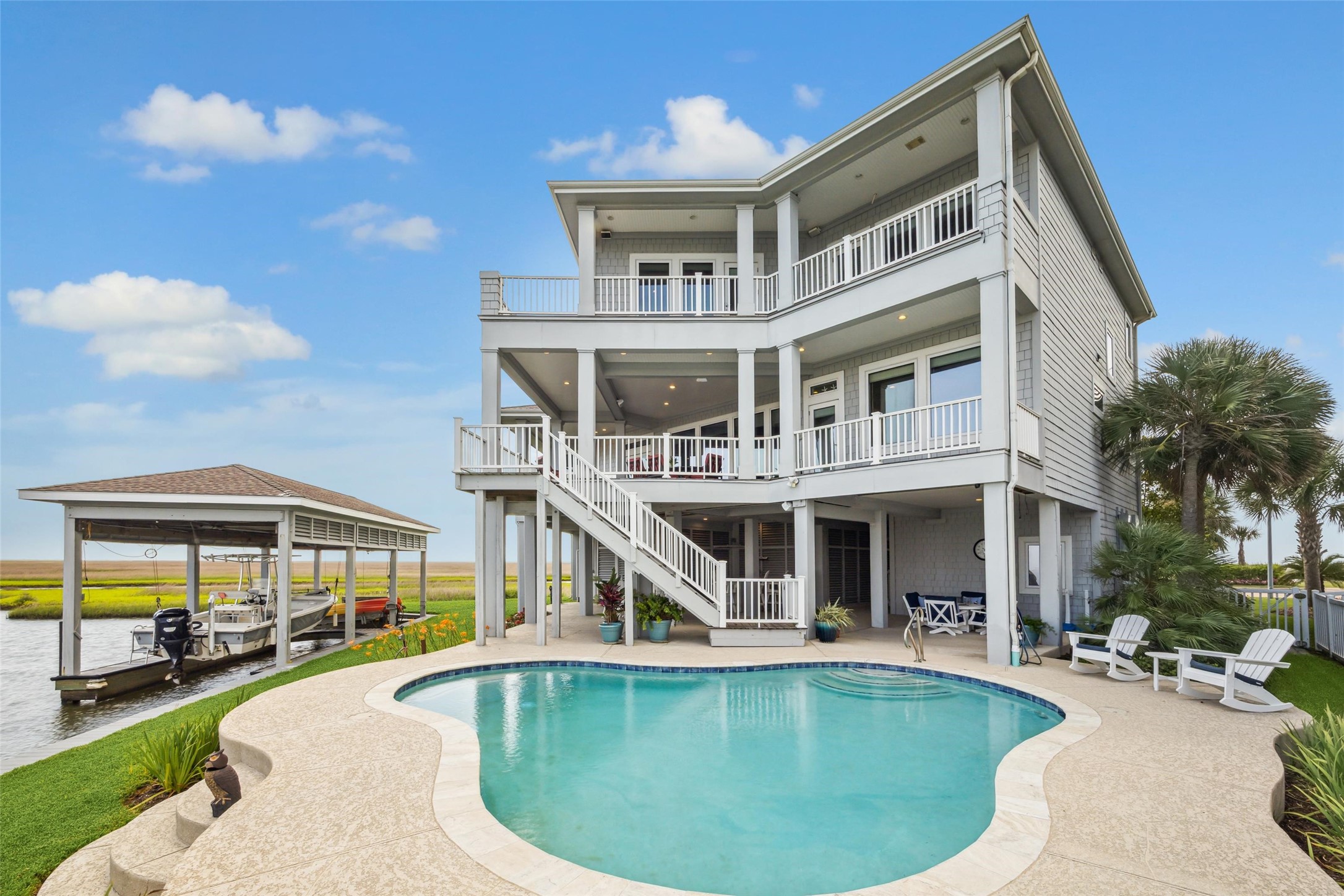 Outdoor living is elevated with premium IPE wood decking on both levelsenjoy a spacious covered deck off the kitchen and family room, a separate sunset-view deck, and upper-level covered and open decks off both the primary and secondary primary suites