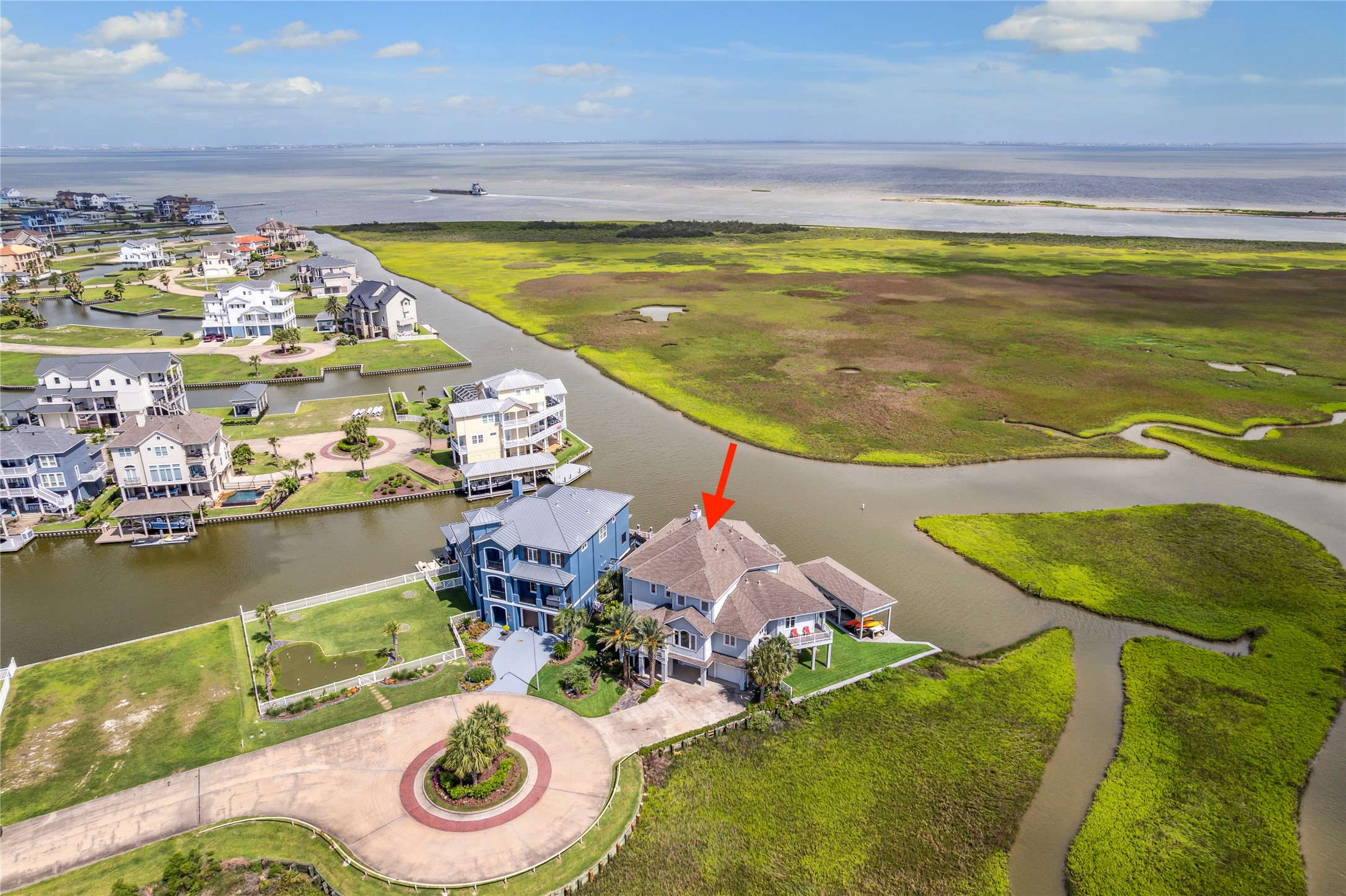 This stunning waterfront home is perfectly positioned at the tip of a cul-de-sac on a premier homesite offering unparalleled privacy and panoramic views. Situated along a wide canal with immediate access to West Galveston Bay, the home captures expansive vistas of the coastal wetlands and open water beyond. The unique placement provides unobstructed sightlines in multiple directions, showcasing the beauty of the surrounding nature preserve and vibrant sunsets