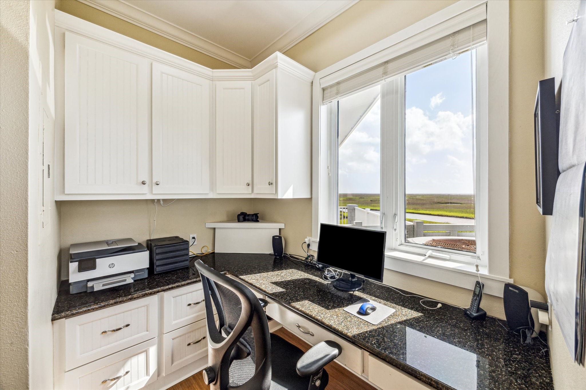Adjacent to the kitchen is a convenient office nook, perfect for staying organized or working from home