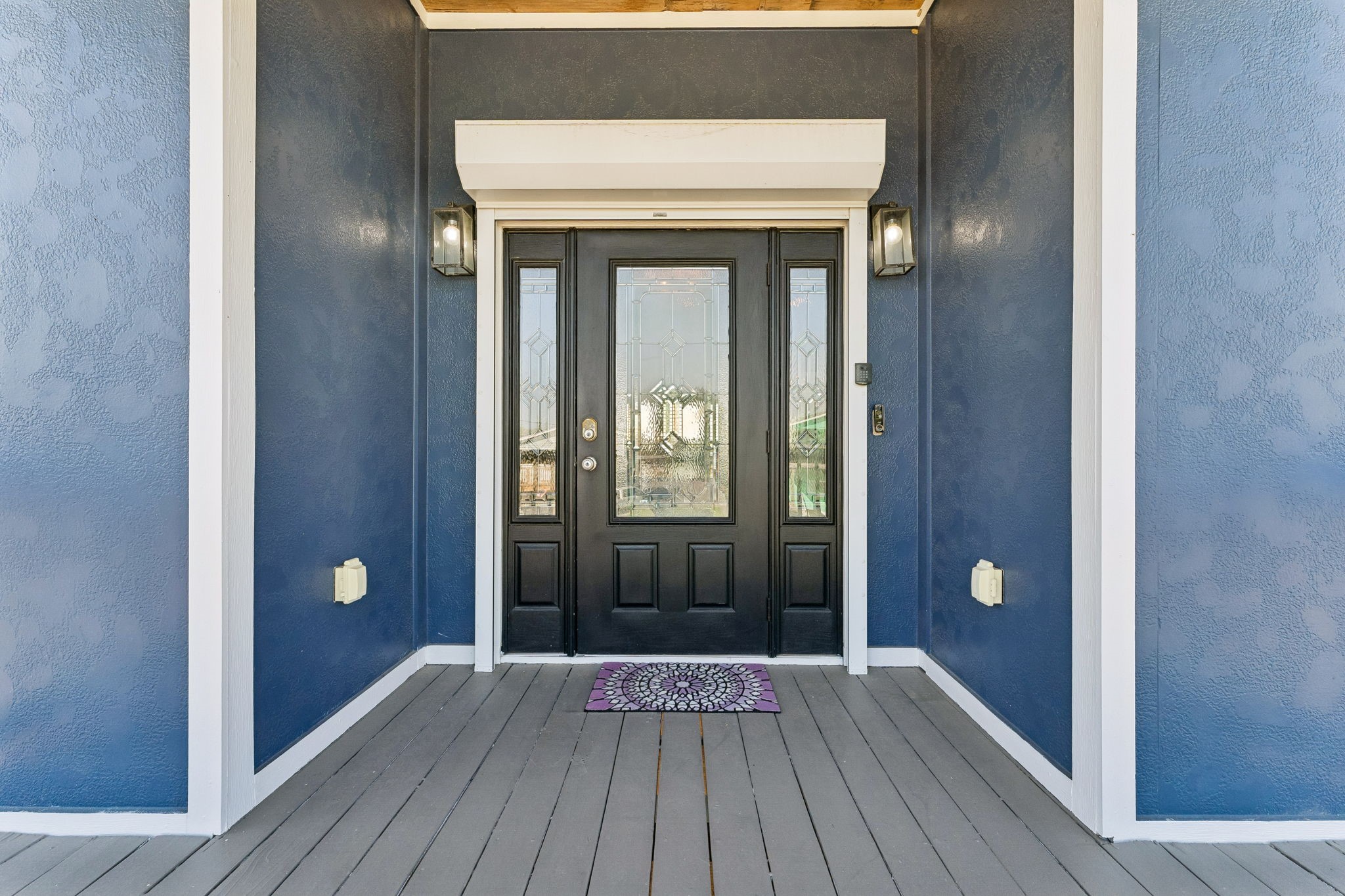 Covered front porch welcomes you with a striking double entry door framed by decorative glass sidelights. A polished first impression sets the tone for the home within.