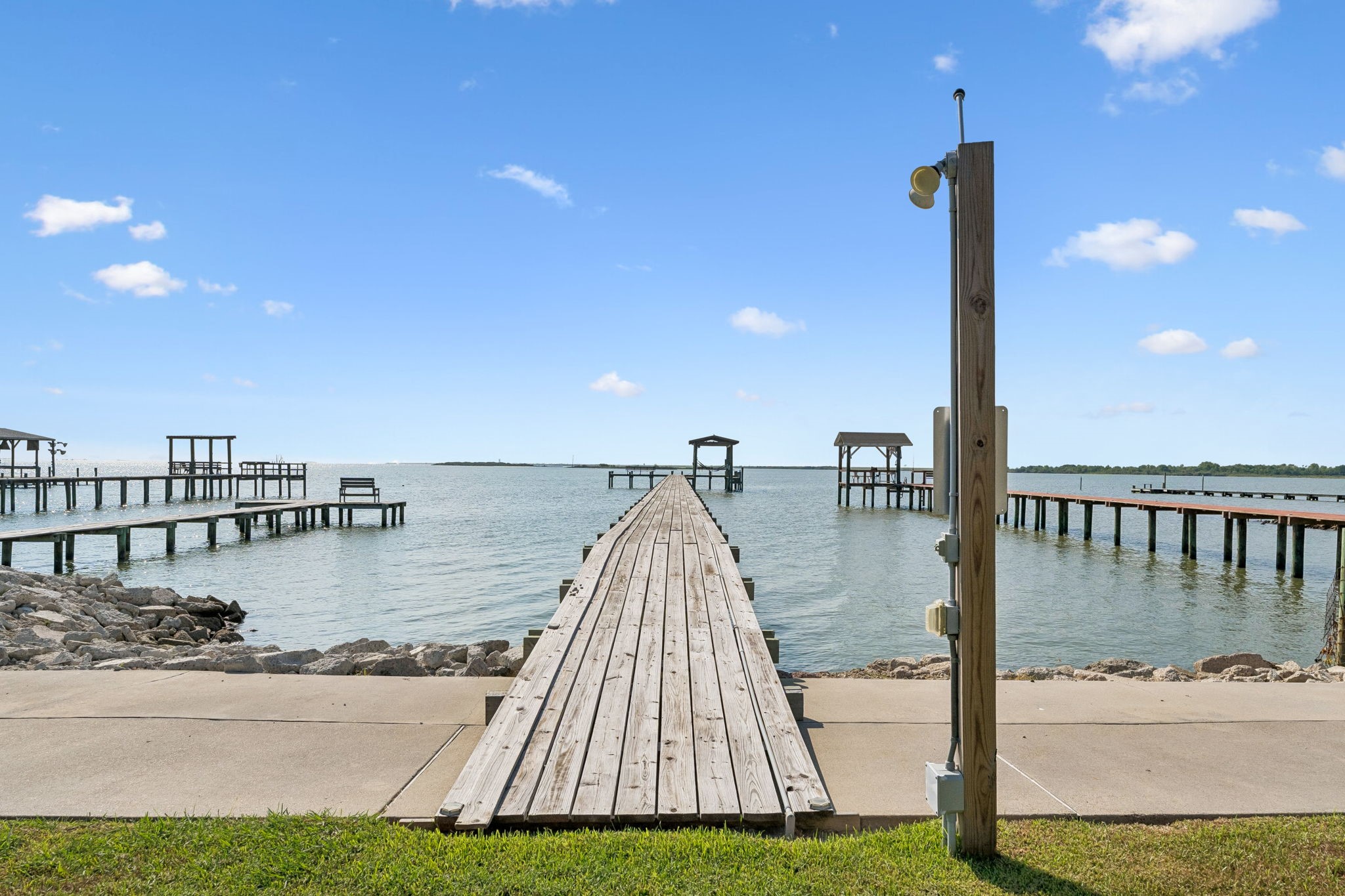 Private pier stretches directly into Galveston Bay, offering effortless access to open water. Sweeping bay views create an incredible setting for fishing, boating, and waterfront living.