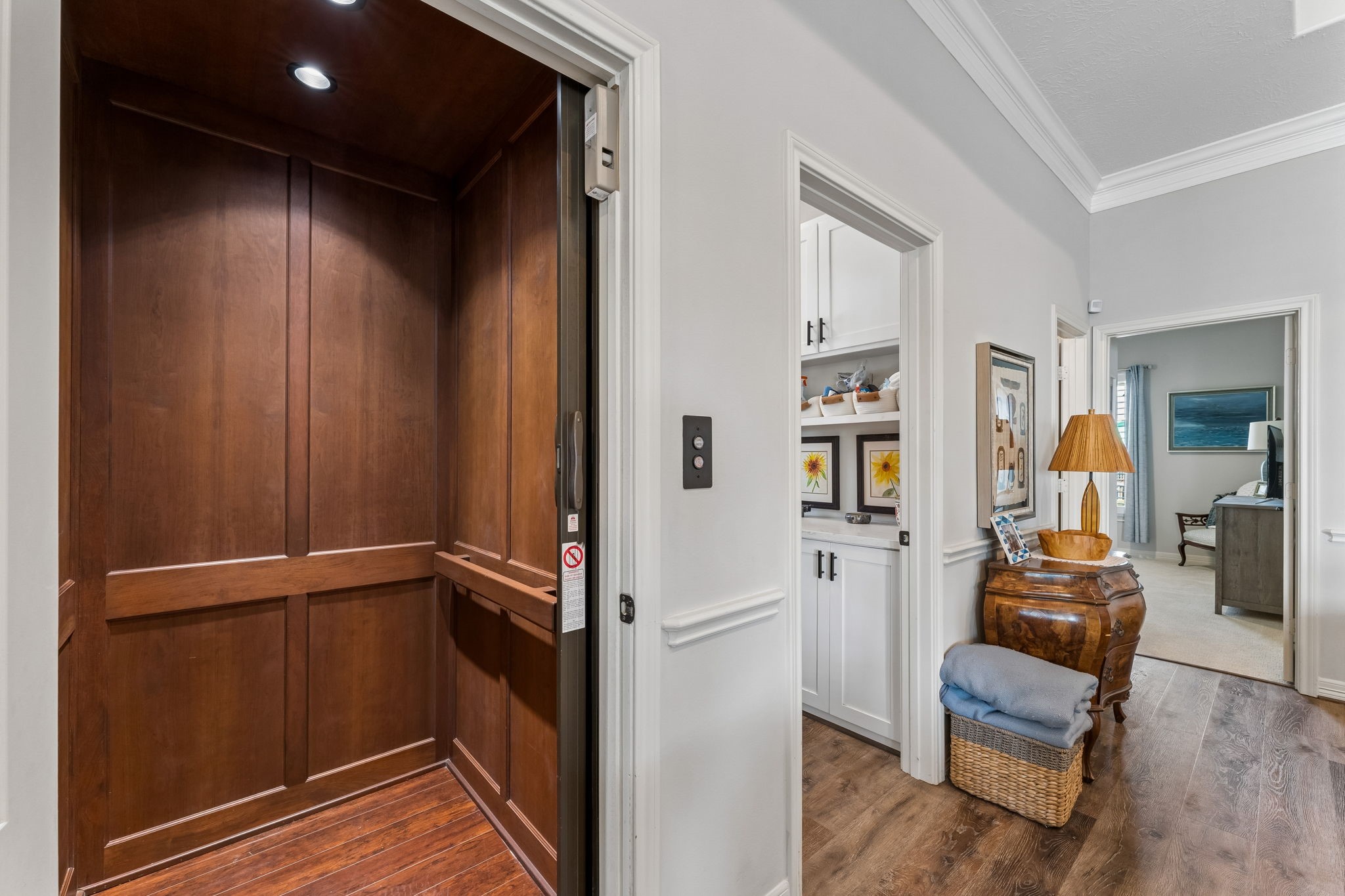 Private residential elevator provides convenient access between levels. Rich wood paneling adds a refined touch to this practical luxury feature. Private residential elevator provides convenient access between levels. Rich wood paneling adds a refined touch to this practical luxury feature.