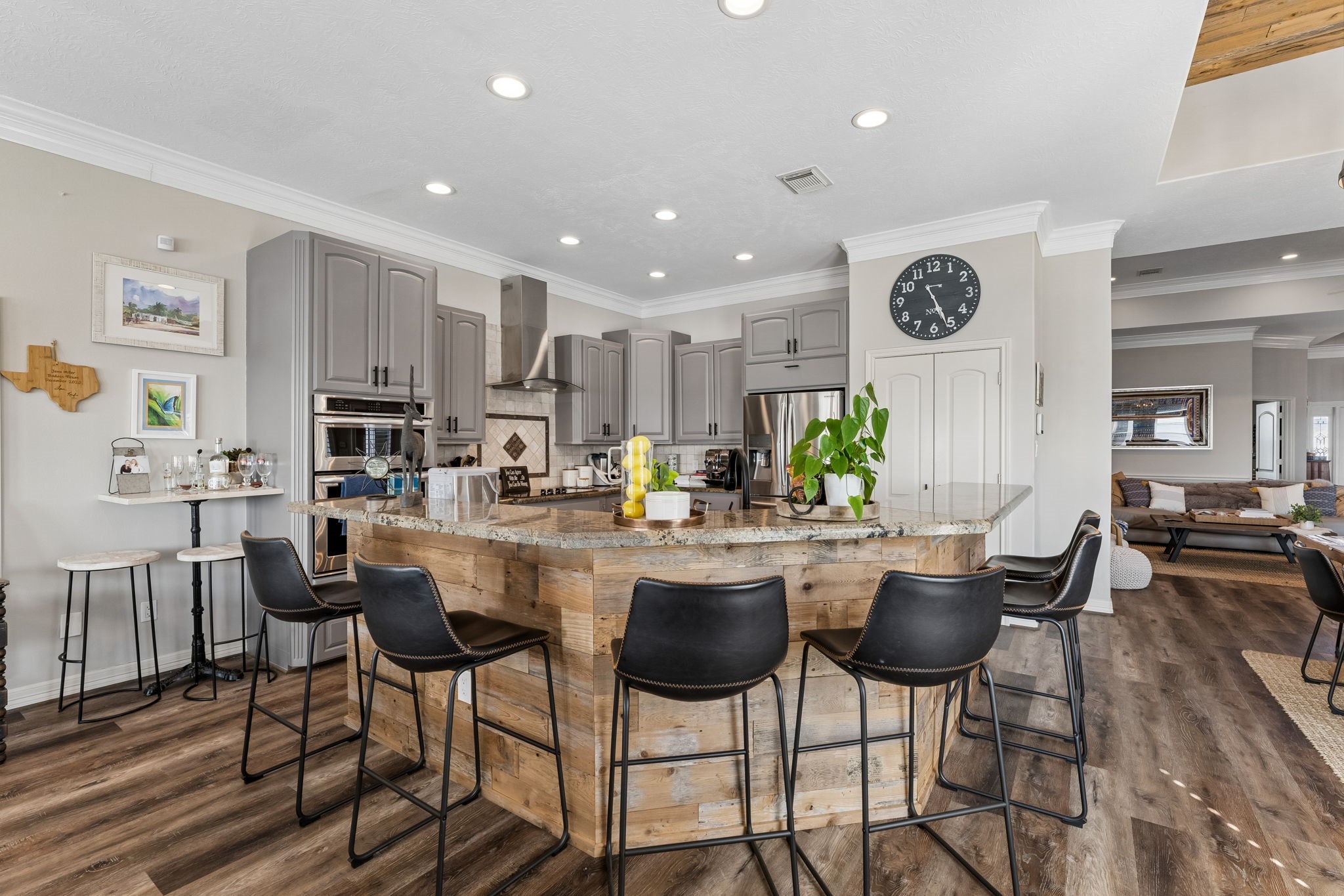 Spacious kitchen island provides generous seating and creates a natural gathering place at the heart of the home. Granite countertops and abundant cabinetry offer plenty of room for cooking, serving, and entertaining.