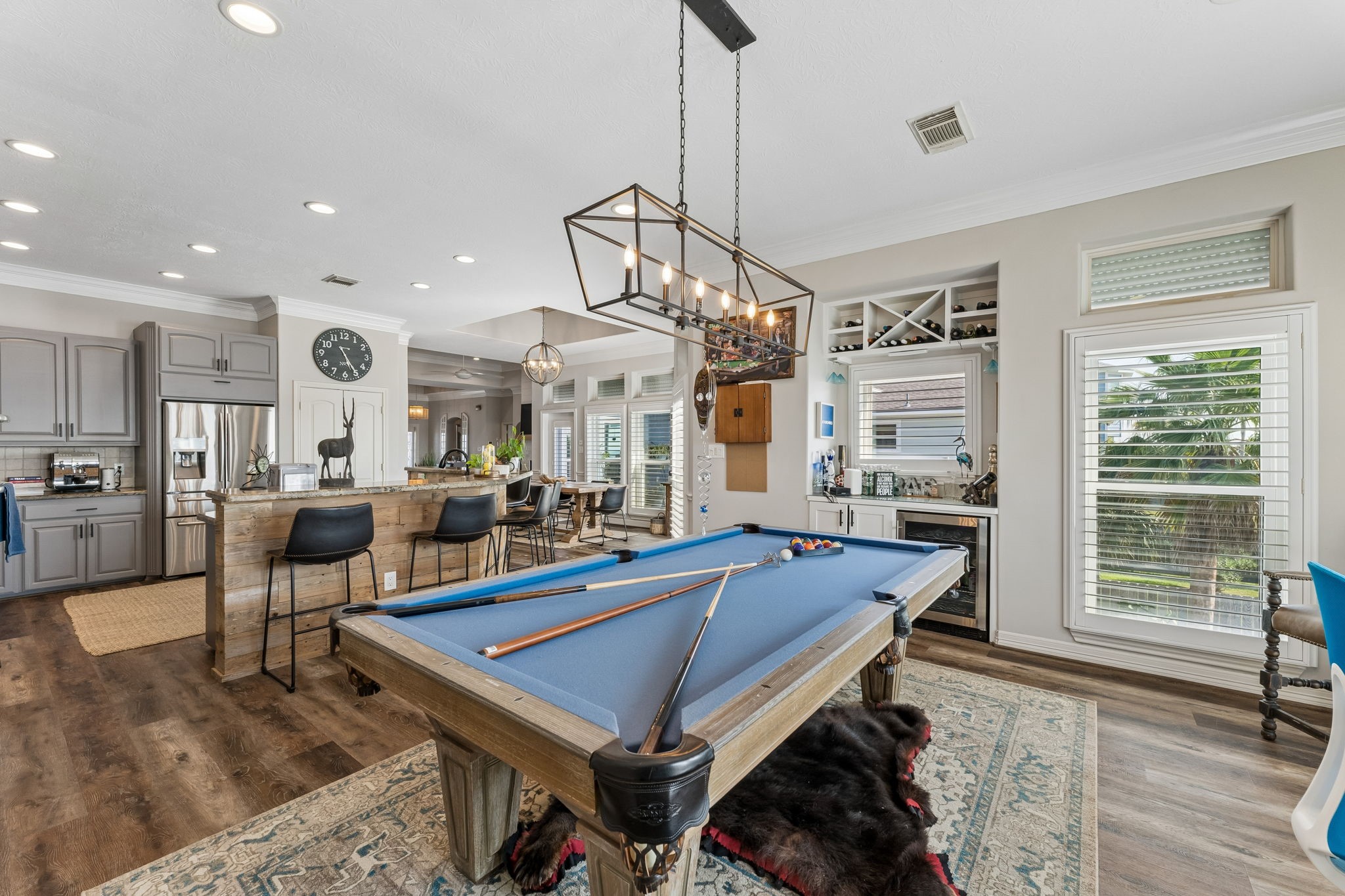 Game room connects effortlessly to the kitchen and features a built in beverage station with wine storage. A full size pool table makes this space ready for entertaining.