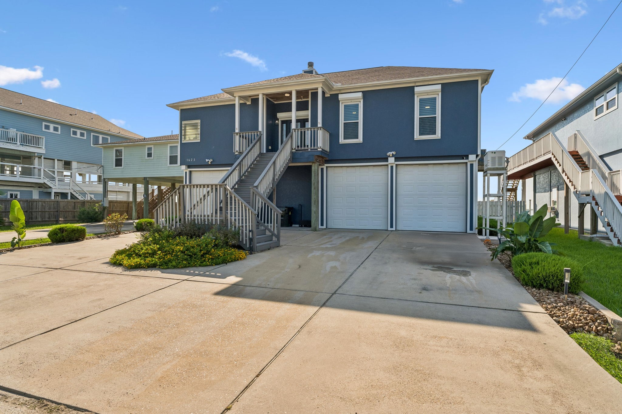 Classic coastal curb appeal with a stately elevated design and inviting covered entry. An expansive driveway provides plenty of space for parking and easy everyday access.
