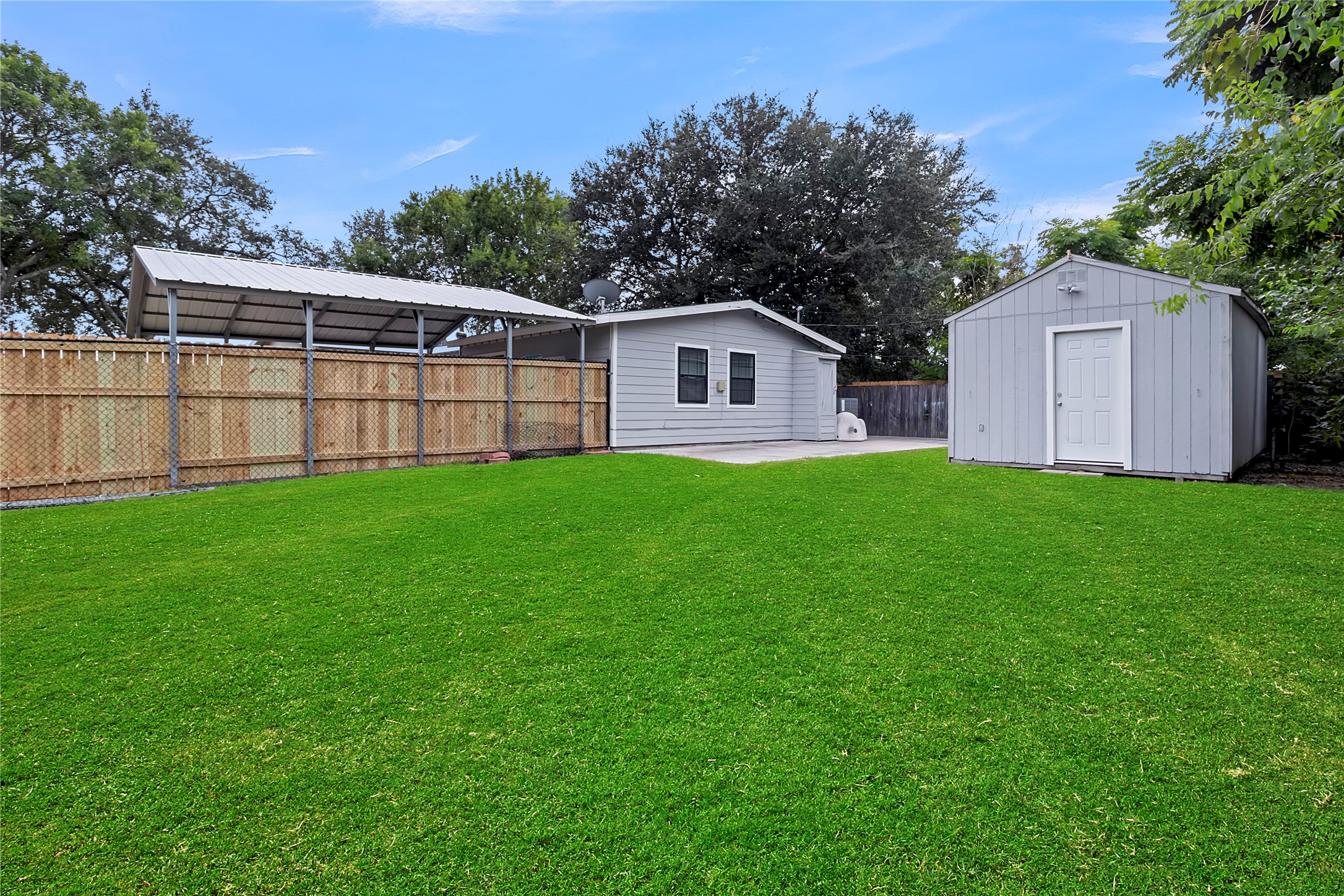 Large backyard offers plenty of usable outdoor space, along with a detached storage shed/workshop equipped with electricity.