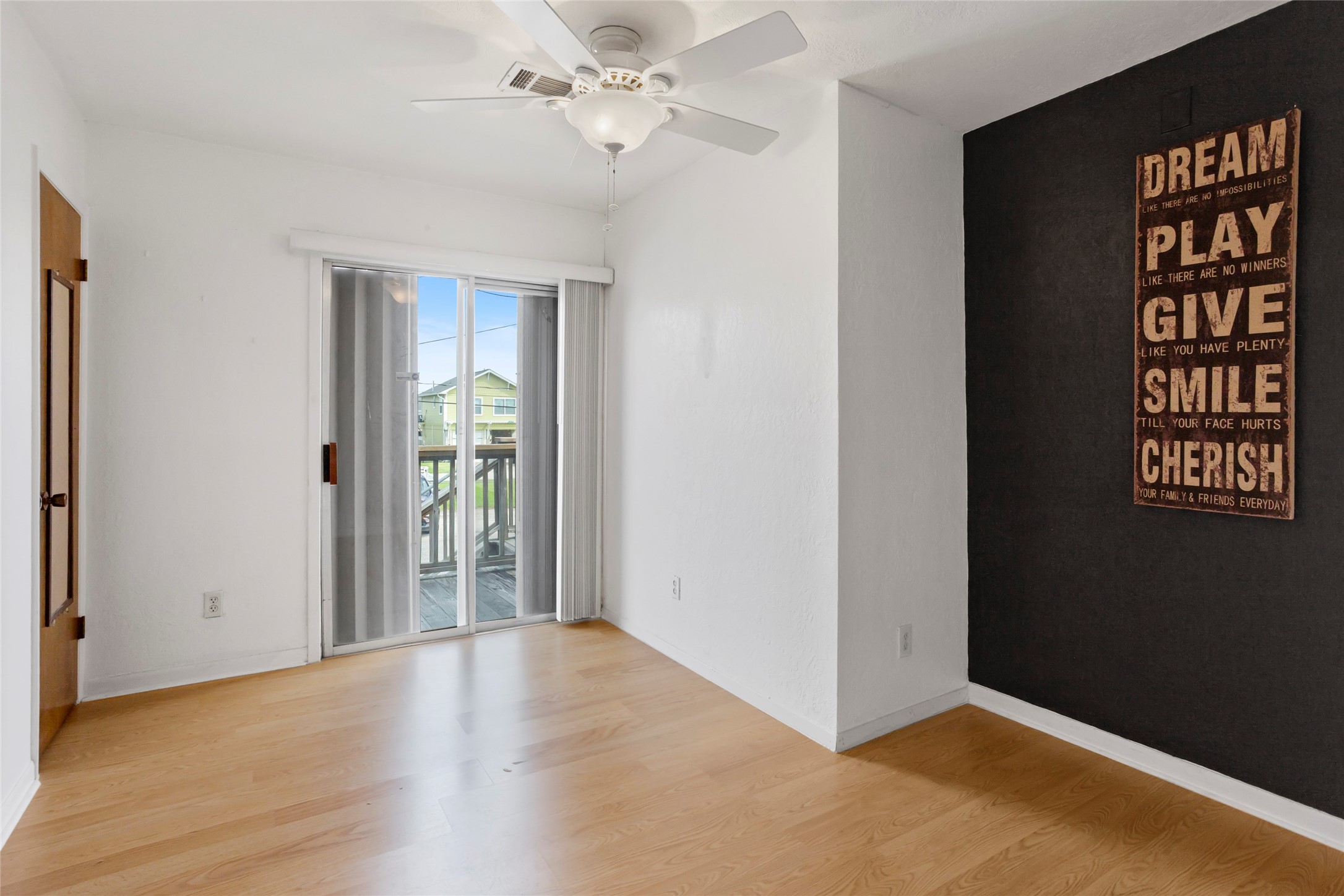 This versatile bedroom or office offers direct access to a spacious front-facing balcony.
