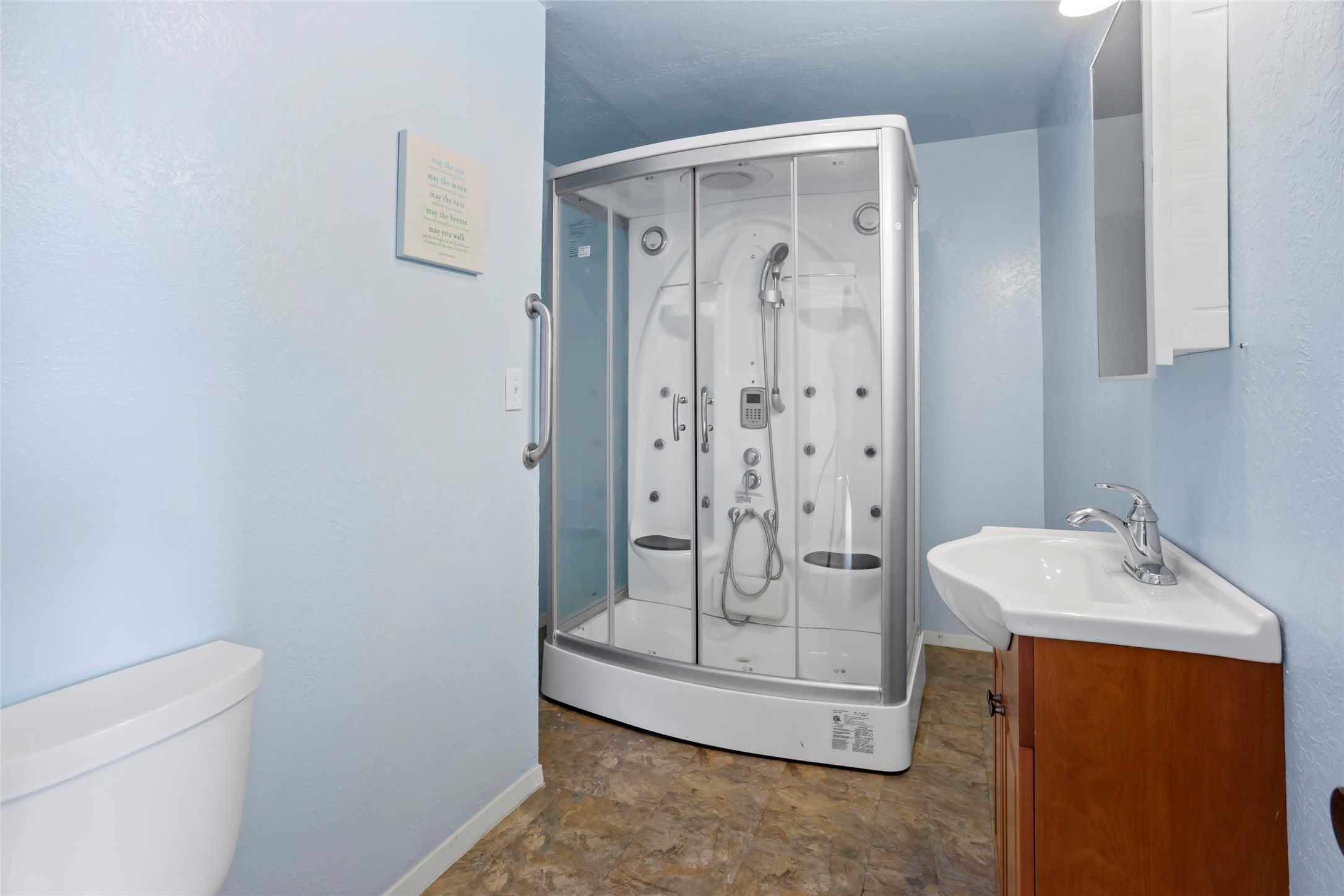 Living area bathroom has the Eagle Bath system which is a steam spa and water
massage shower with interior light and push button controls