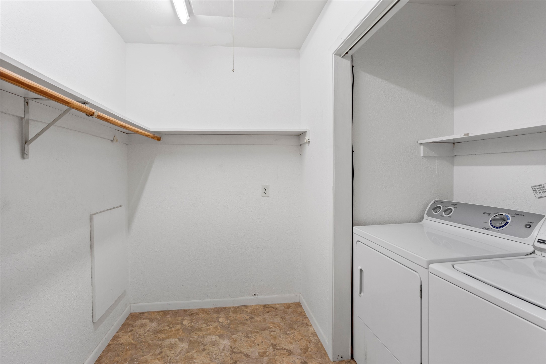 Spacious walk-in closet in the primary bedroom with convenient in-suite laundry.