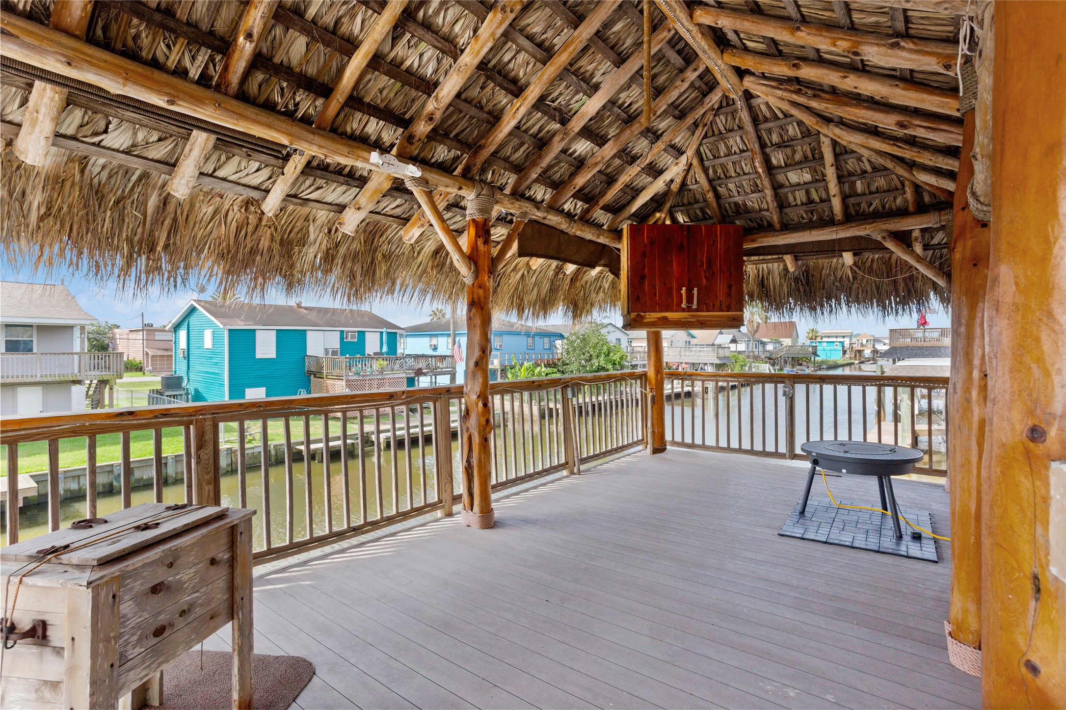 Stunning palapa bar with a cozy fire pit and TV mount, perfect for entertaining.