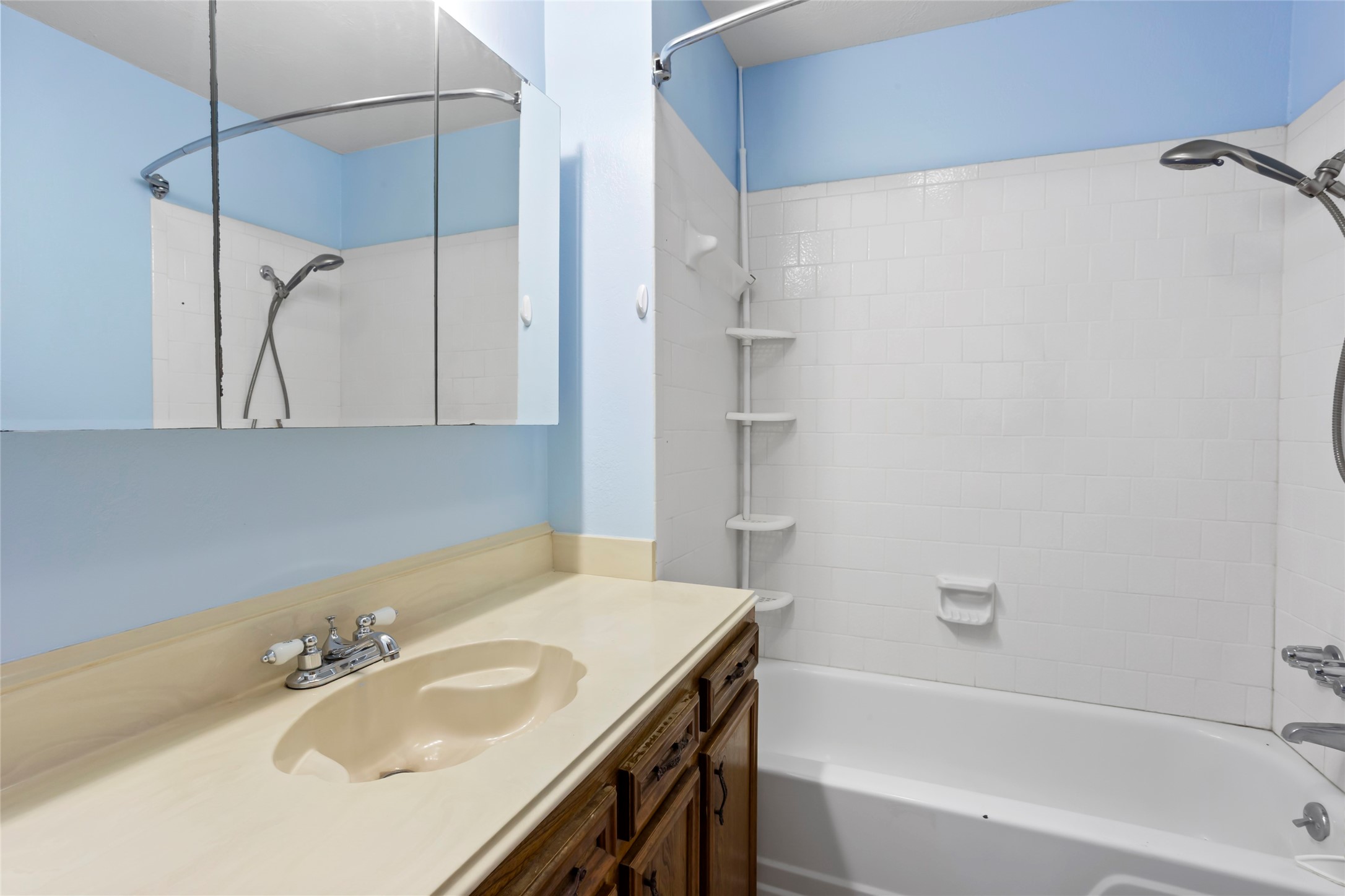 Elegant ensuite bathroom with a sleek vanity, ample storage, and a modern shower-tub combination for ultimate relaxation.
