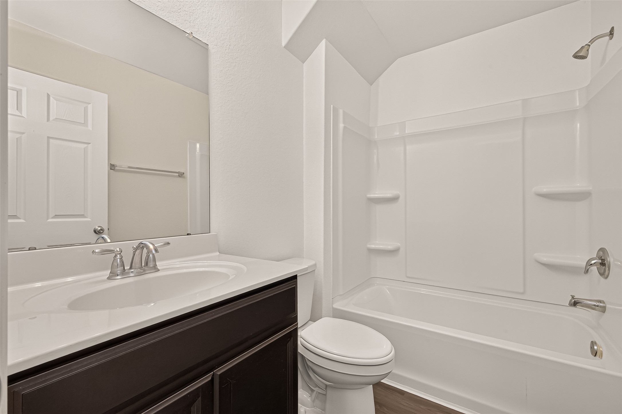 Convenient first-floor secondary bathroom featuring a practical tub/shower combination, thoughtfully designed for comfort, functionality, and everyday convenience