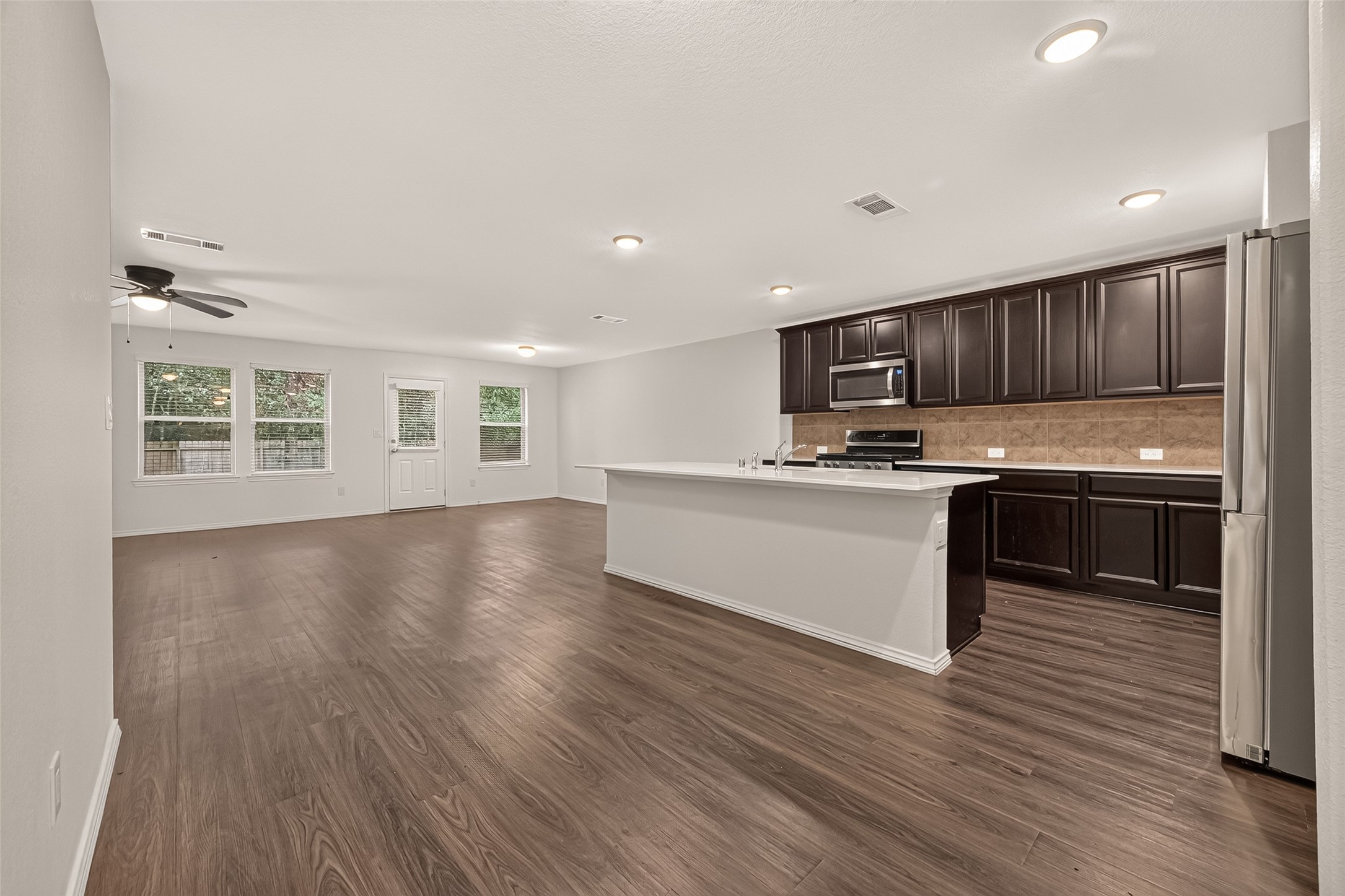 Open-concept living space offering a seamless flow between gathering areas, creating an inviting atmosphere perfect for family gatherings, entertaining, and everyday living