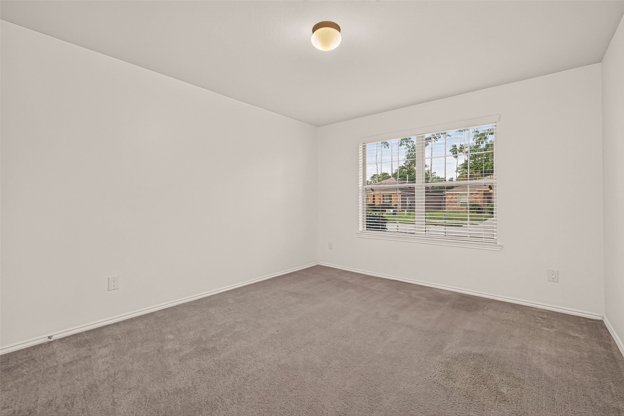 Spacious first-floor secondary bedroom offering a comfortable and versatile layout, perfect for family members or overnight guests seeking convenience and privacy.