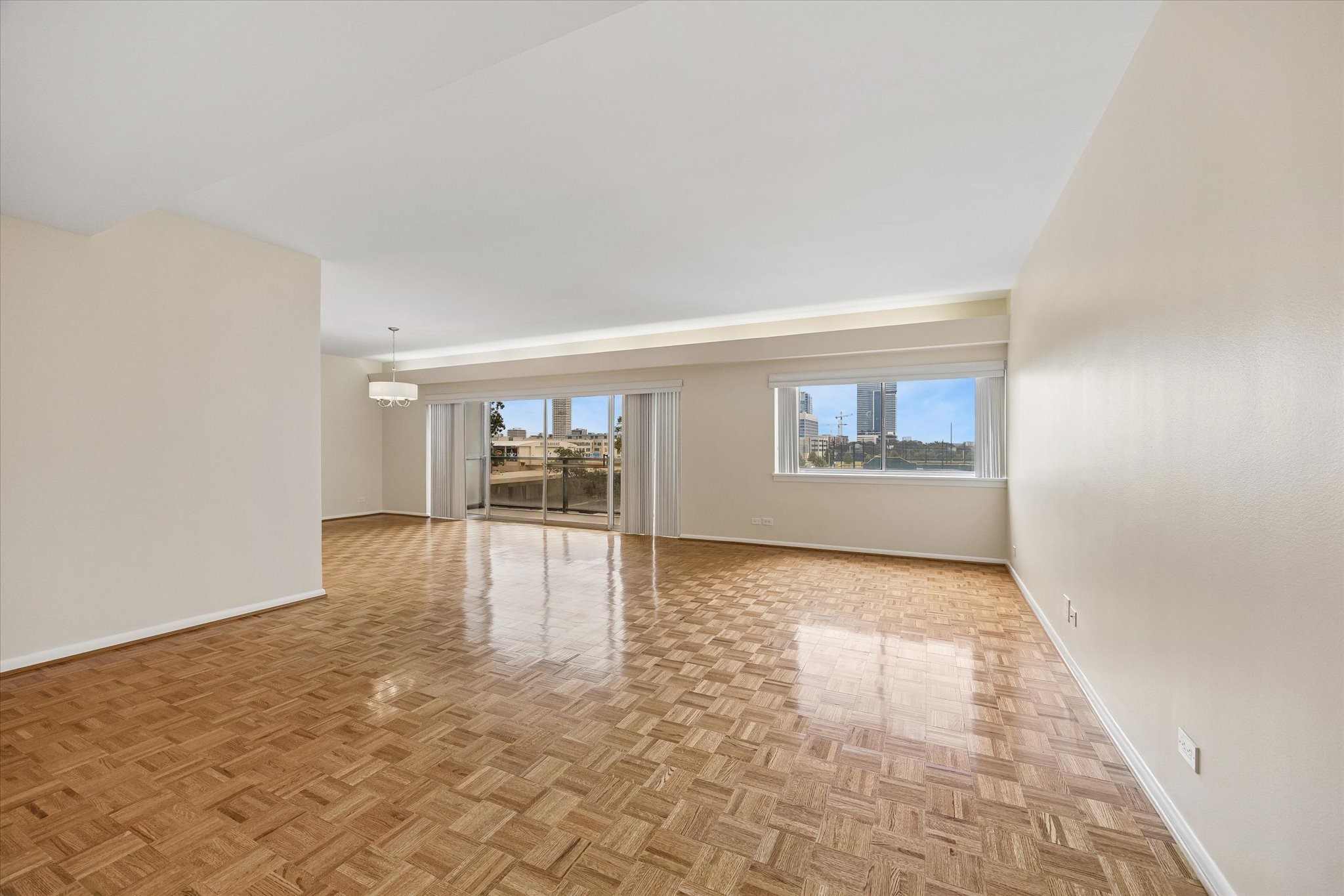 Large Living Room (16.5 x 21.5) with plantation shutters and parkay flooring