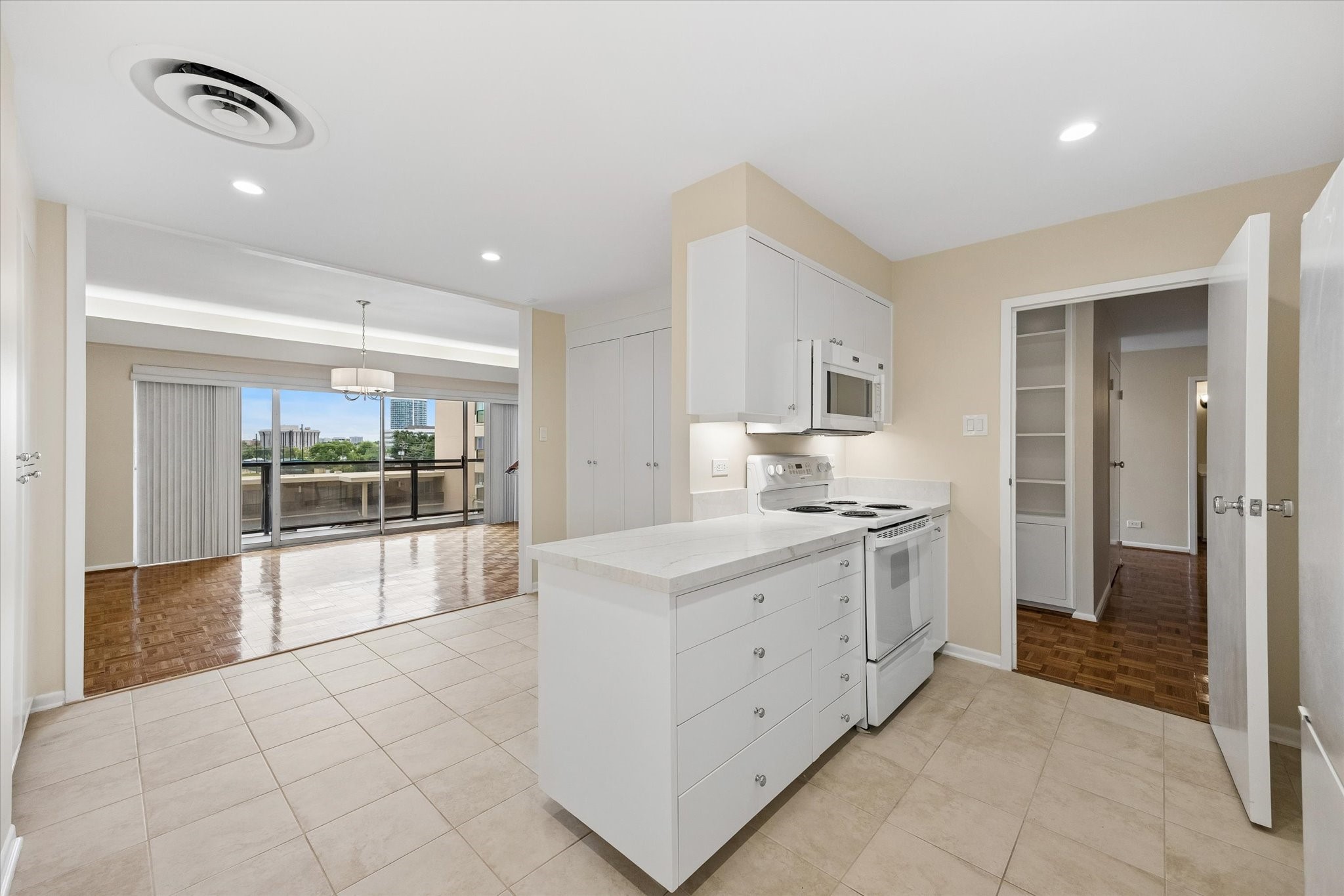 Kitchen with new granite countertops and island looking towards balcony