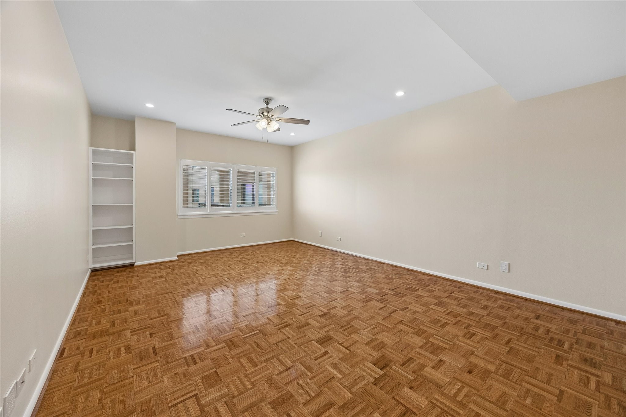 Large Master Bedroom (15.5 x 21.1) with gorgeous parkay flooring and plantation shutters