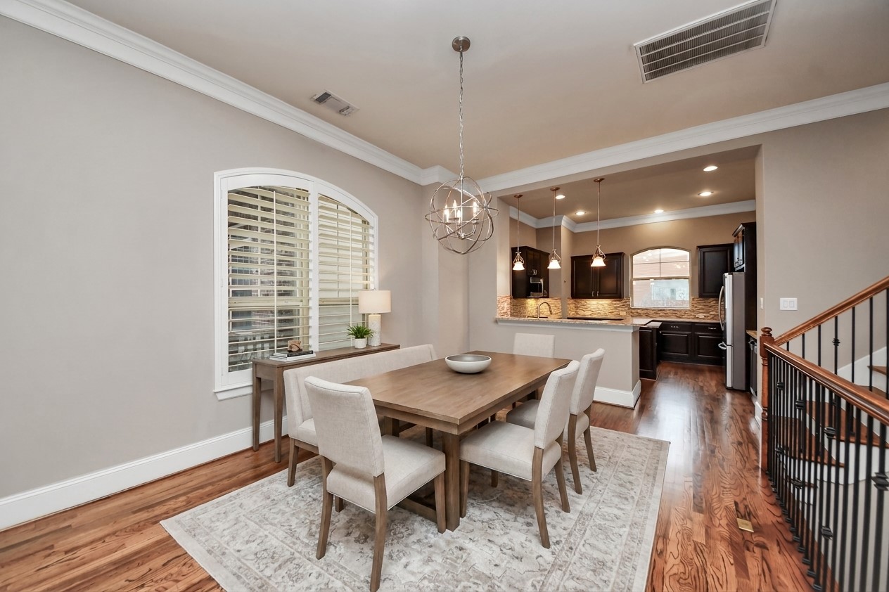 Virtually Staged - Experience the perfect blend of elegance and functionality in this dining area, seamlessly flowing into a modern kitchen, ideal for both entertaining and everyday living.