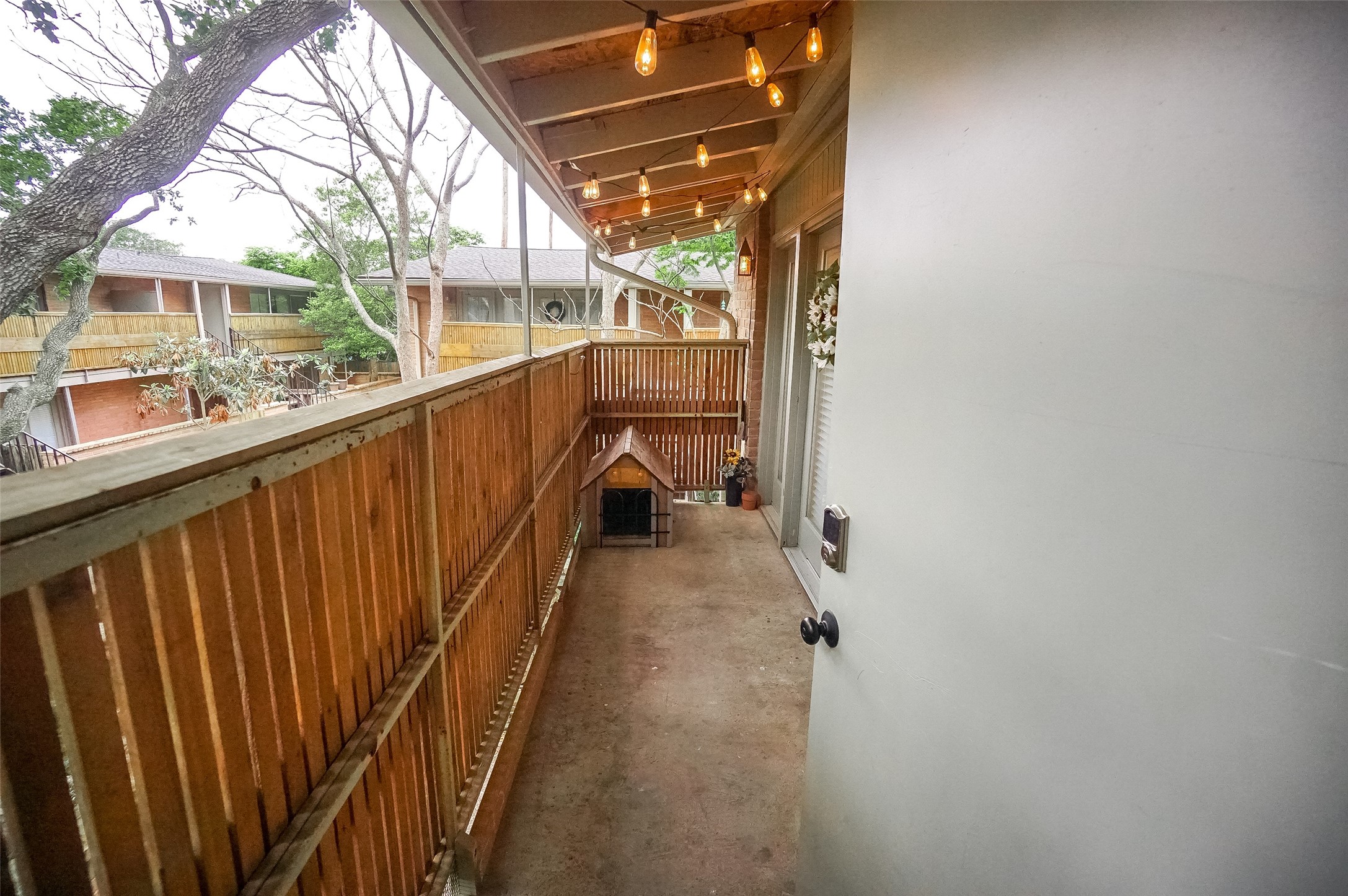 Another view of the front porch that shows the patio door with lock.