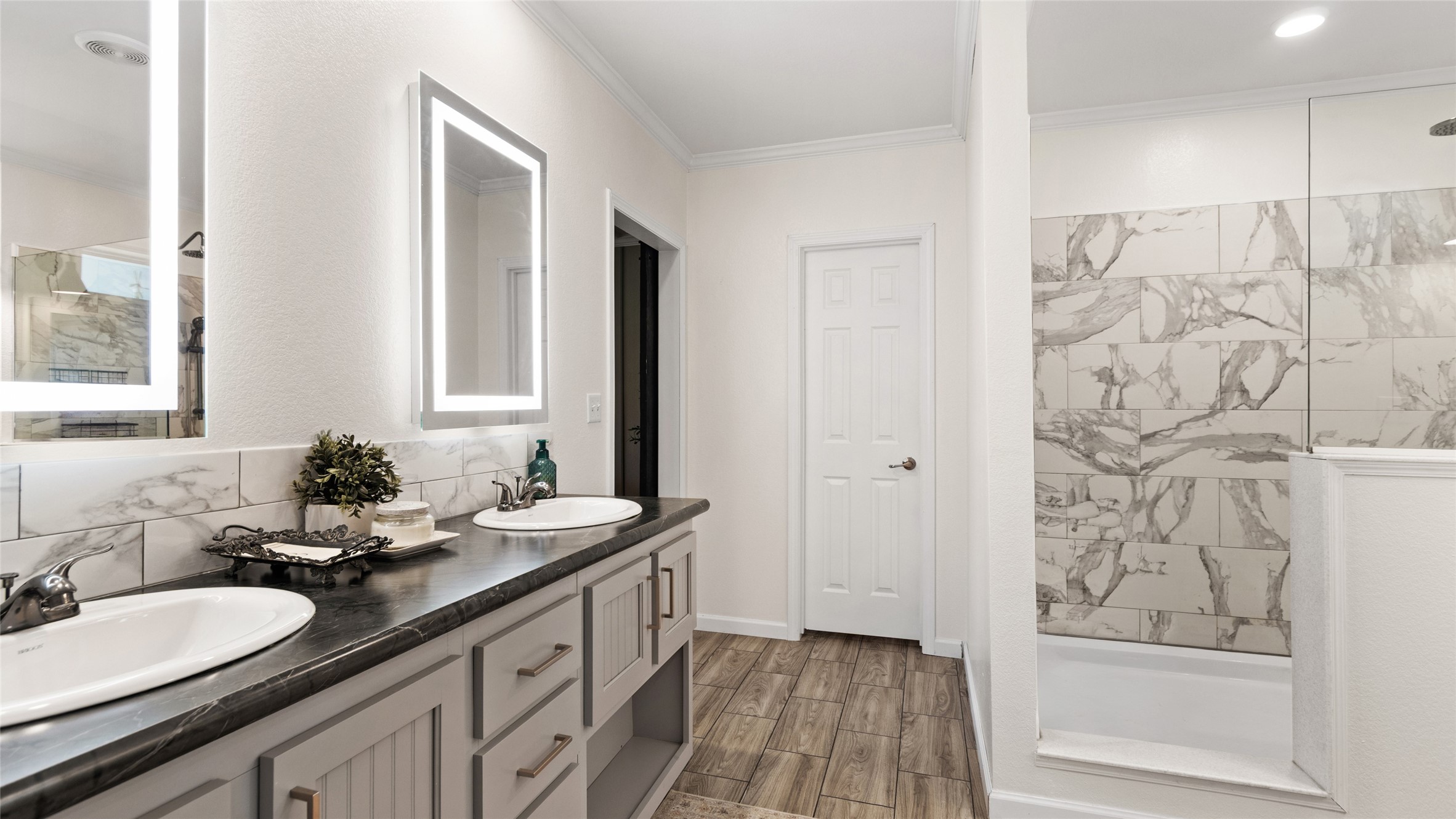 Secondary primary en-suite bathroom with double vanities and standing shower only