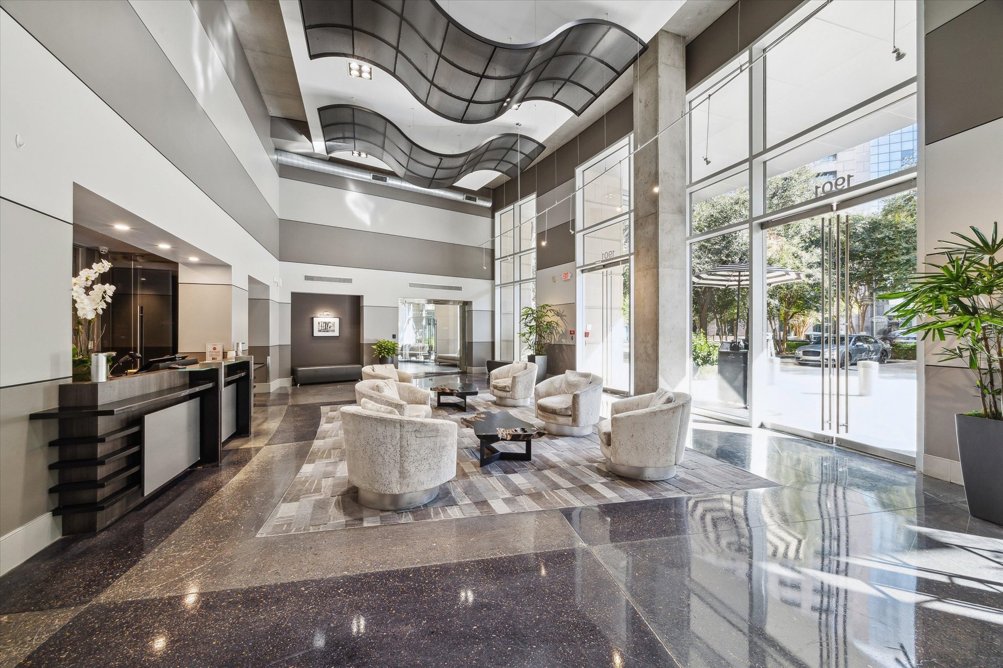 Sophisticated lobby with high ceilings, modern decor, and abundant natural light, featuring stylish seating and a sleek reception area.  Valet your car, pick up your packages, grab your food order or coffee from the coffee bar and head home.  I hang out in the lobby and meet your neighbors.  Fun and social building.