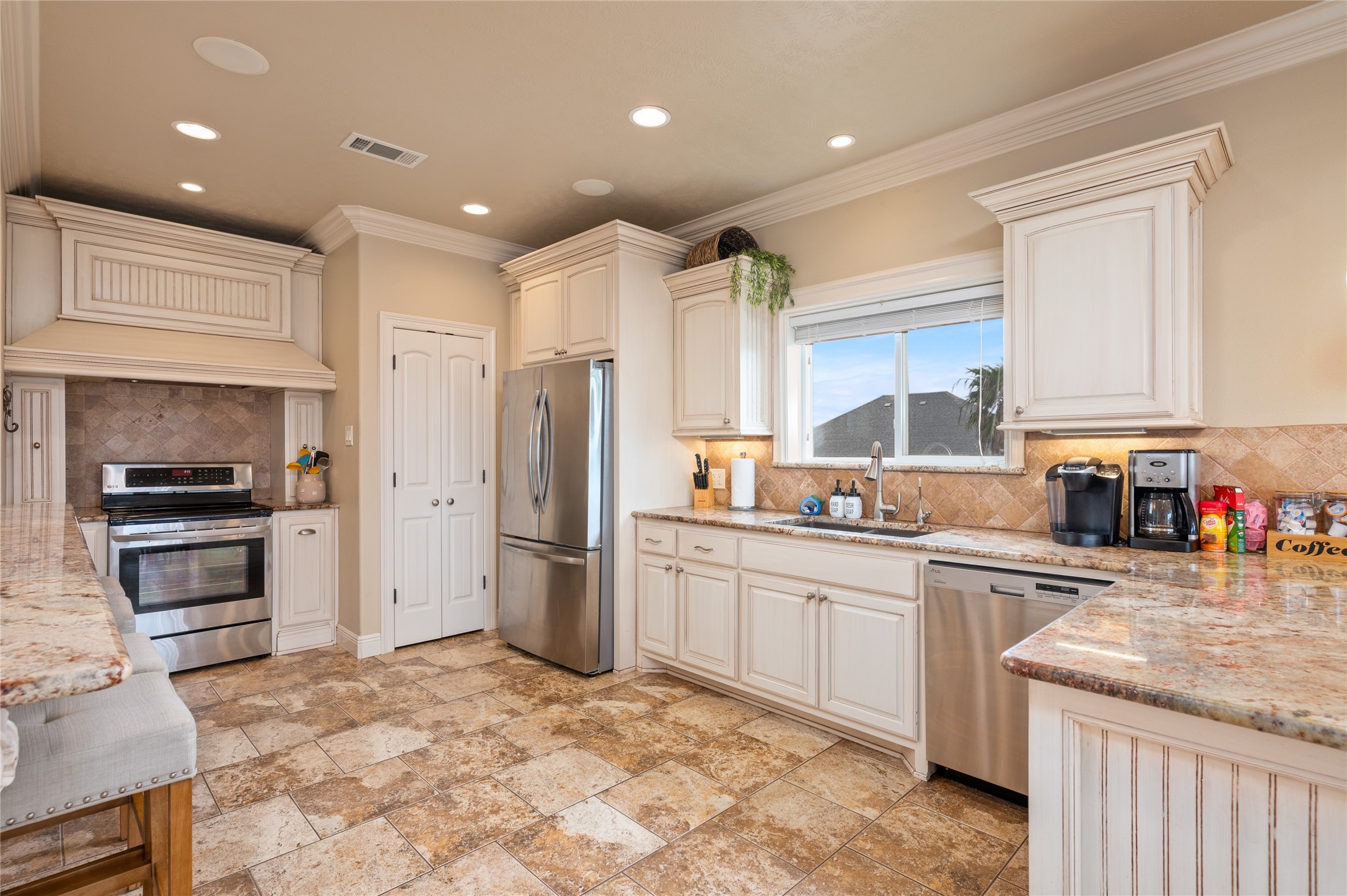 Cooking feels effortless in your spacious kitchen with granite counters, abundant cabinetry, stainless appliances, and plenty of prep space.