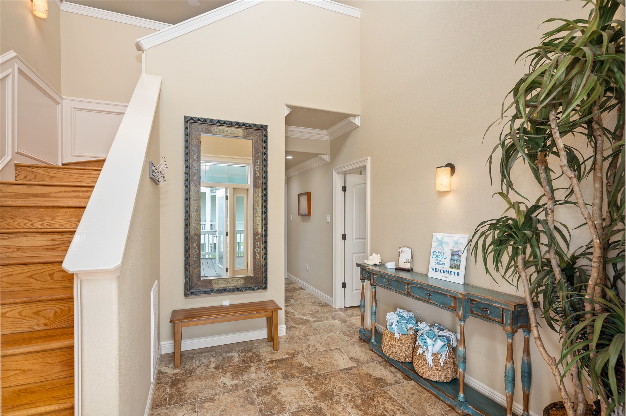 Coming home feels effortless through this welcoming entry, where tile flooring and a convenient staircase lead you into the rest of your coastal retreat.
