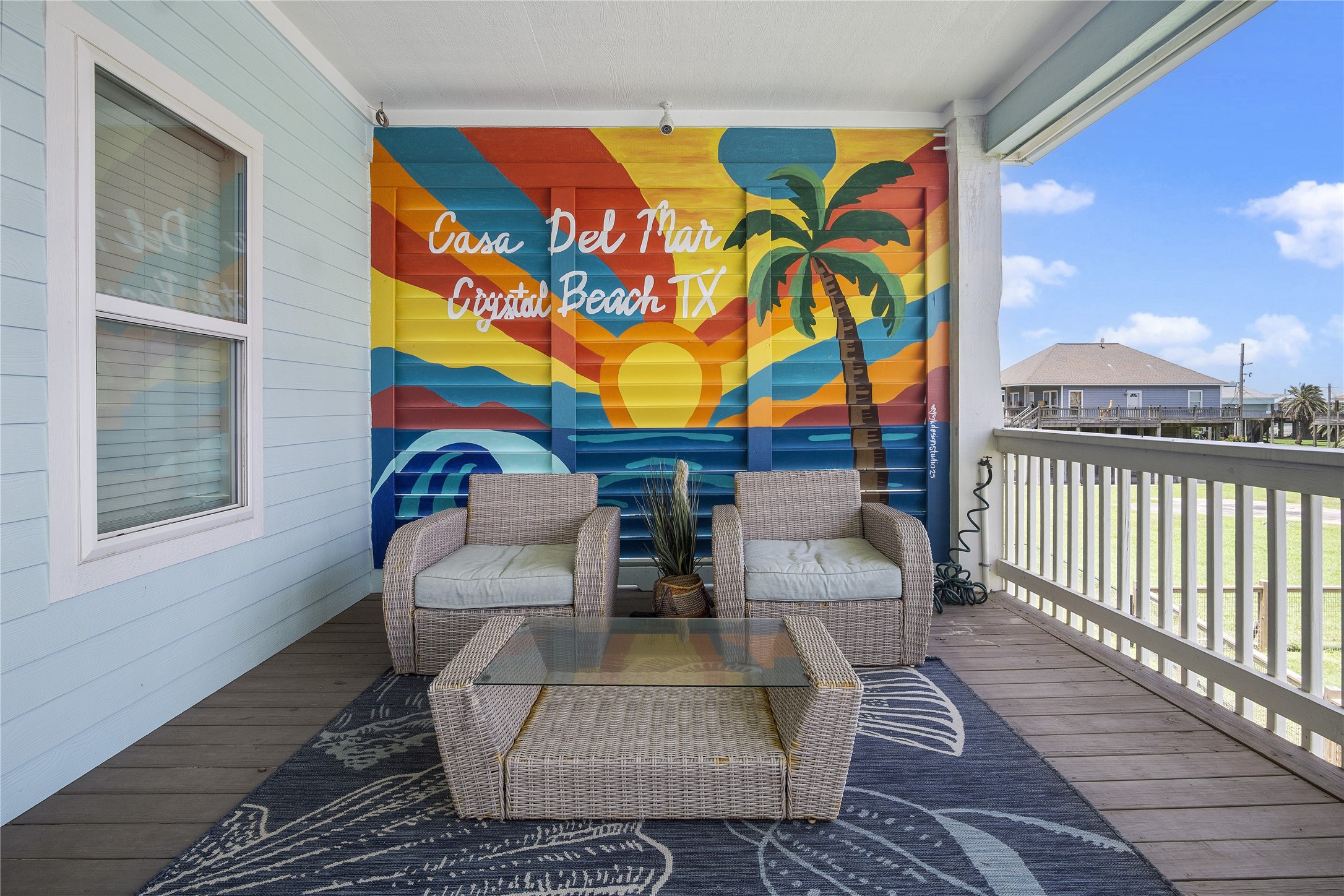 Morning coffee has its own favorite spot on this covered balcony, complete with comfortable seating and a colorful Crystal Beach mural. Morning coffee has its own favorite spot on this covered balcony, complete with comfortable seating and a colorful Crystal Beach mural.