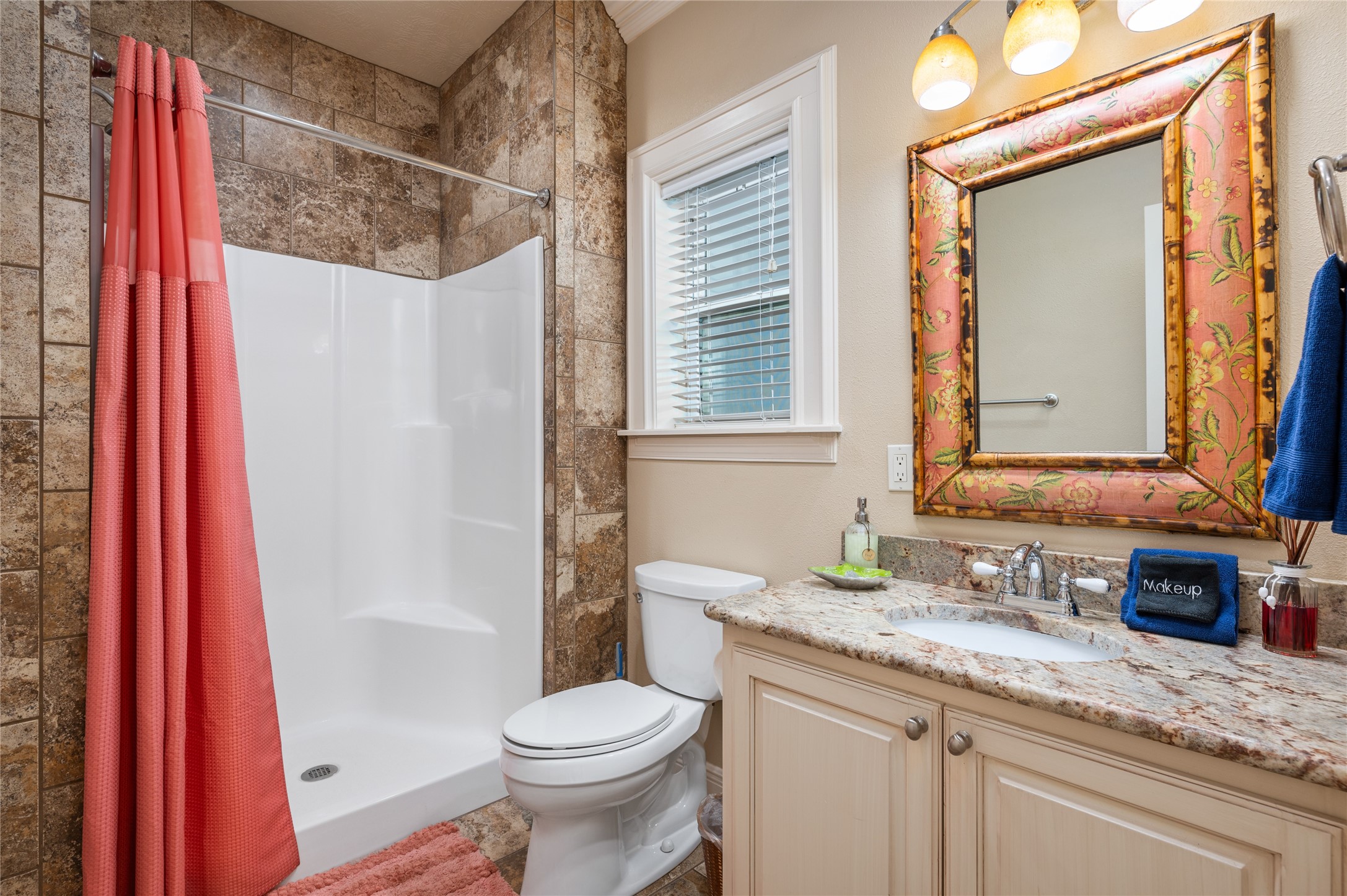 Your private bathroom features a granite-topped vanity and tiled shower surround, making everyday routines easy after a day at the beach.