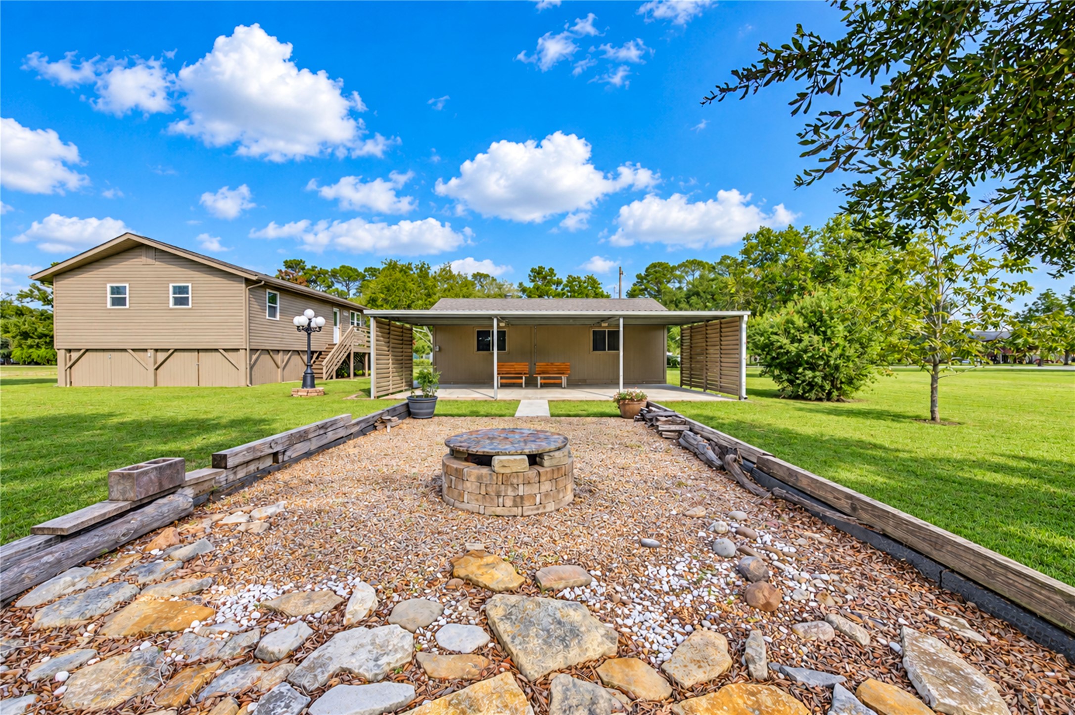 Additional covered outdoor space with the carport extending from the rear of the garage