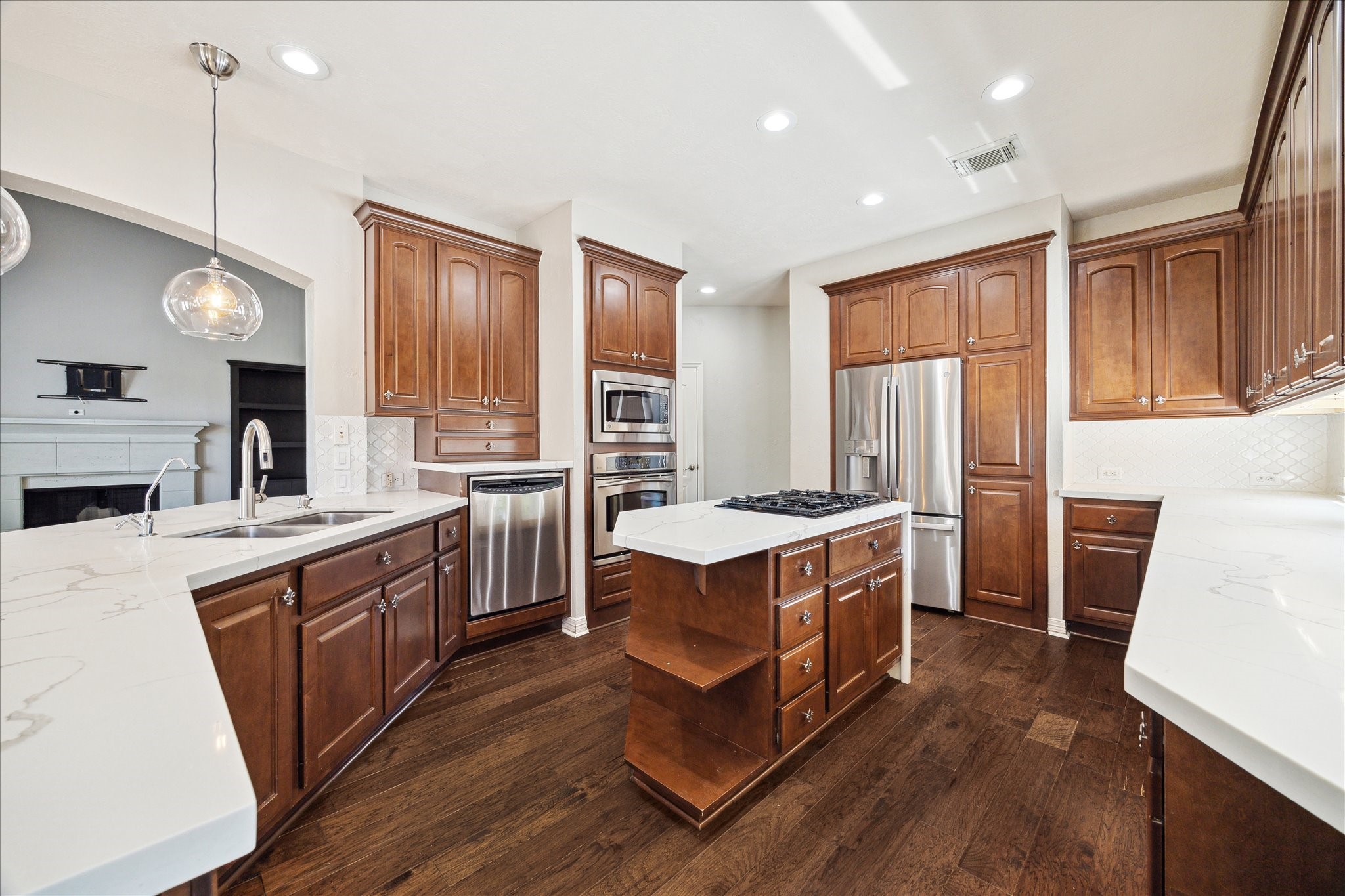 Updated kitchen w top of the line stainless appliances, Quartz counters & tile backsplash