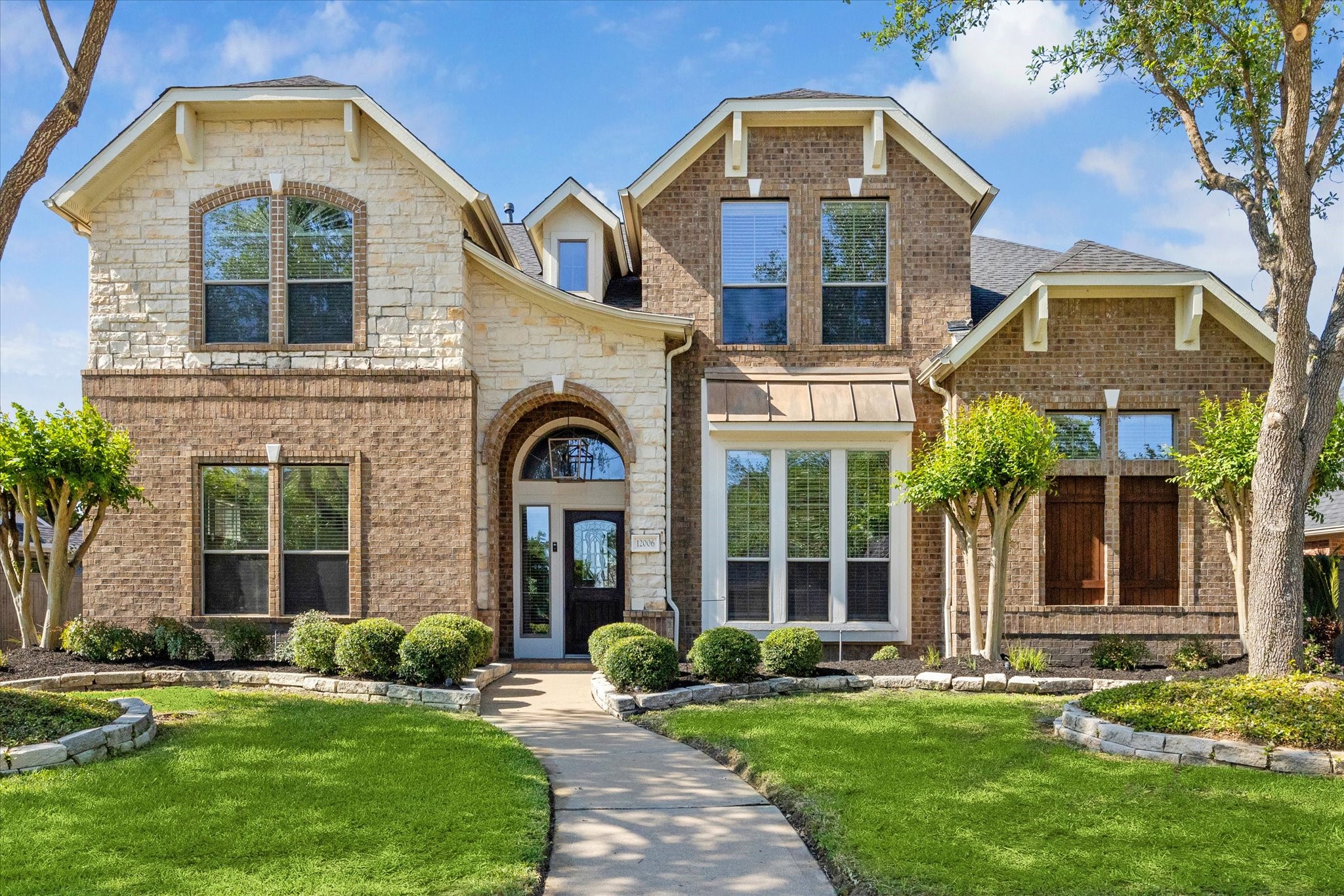Custom stone & brick elevation by Trendmaker Builders Custom stone & brick elevation by Trendmaker Builders