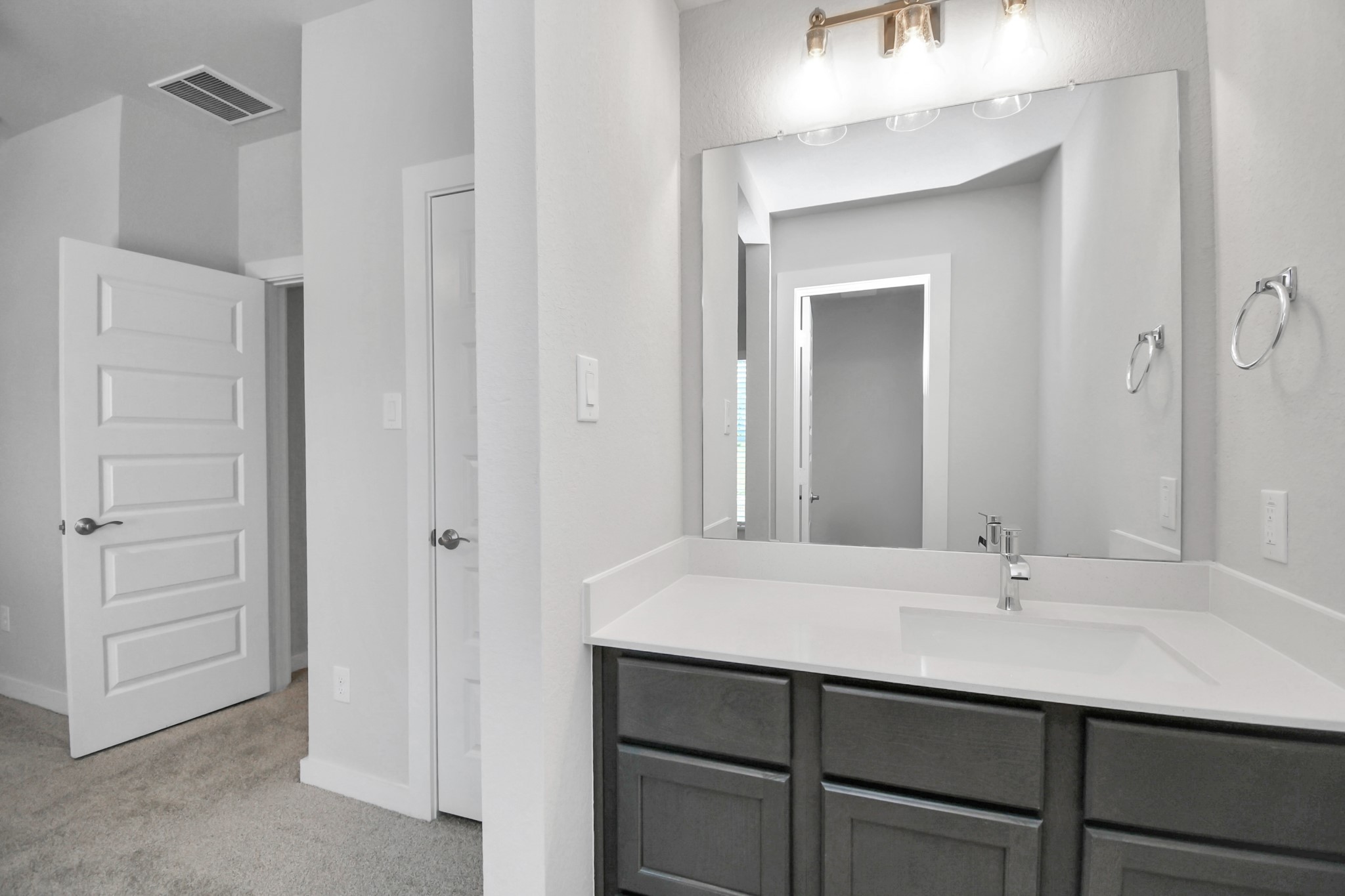 Secondary bath features tile flooring, bath/shower combo with tile surround, light stained wood cabinets, beautiful light countertop. Sample photo of completed home with similar floor plan. Actual colors and selections may vary.