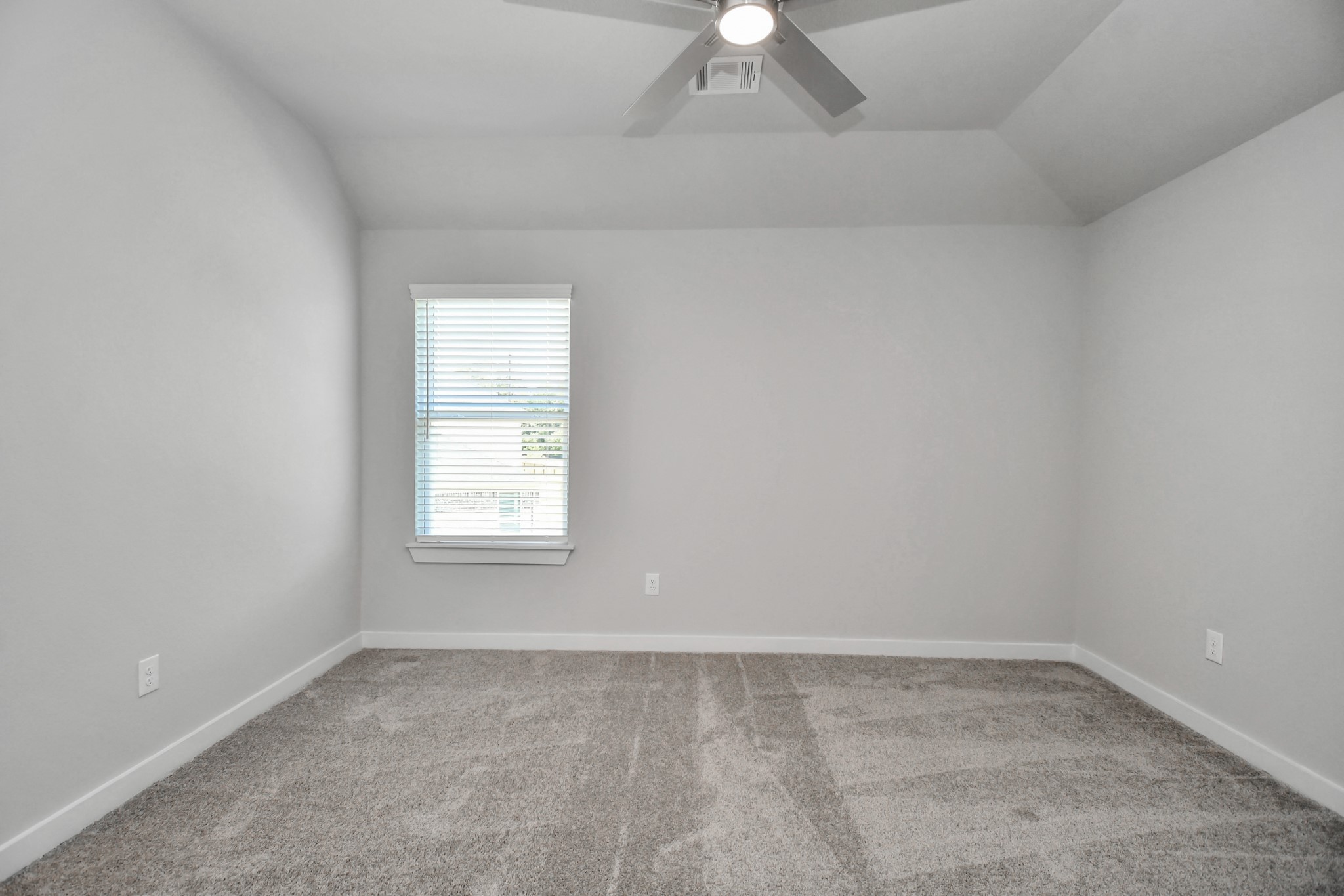Secondary bedroom features plush carpeting, large windows that let in plenty of natural light, bright paint, and spacious closets. Sample photo of completed home with similar floor plan. Actual colors and selections may vary.