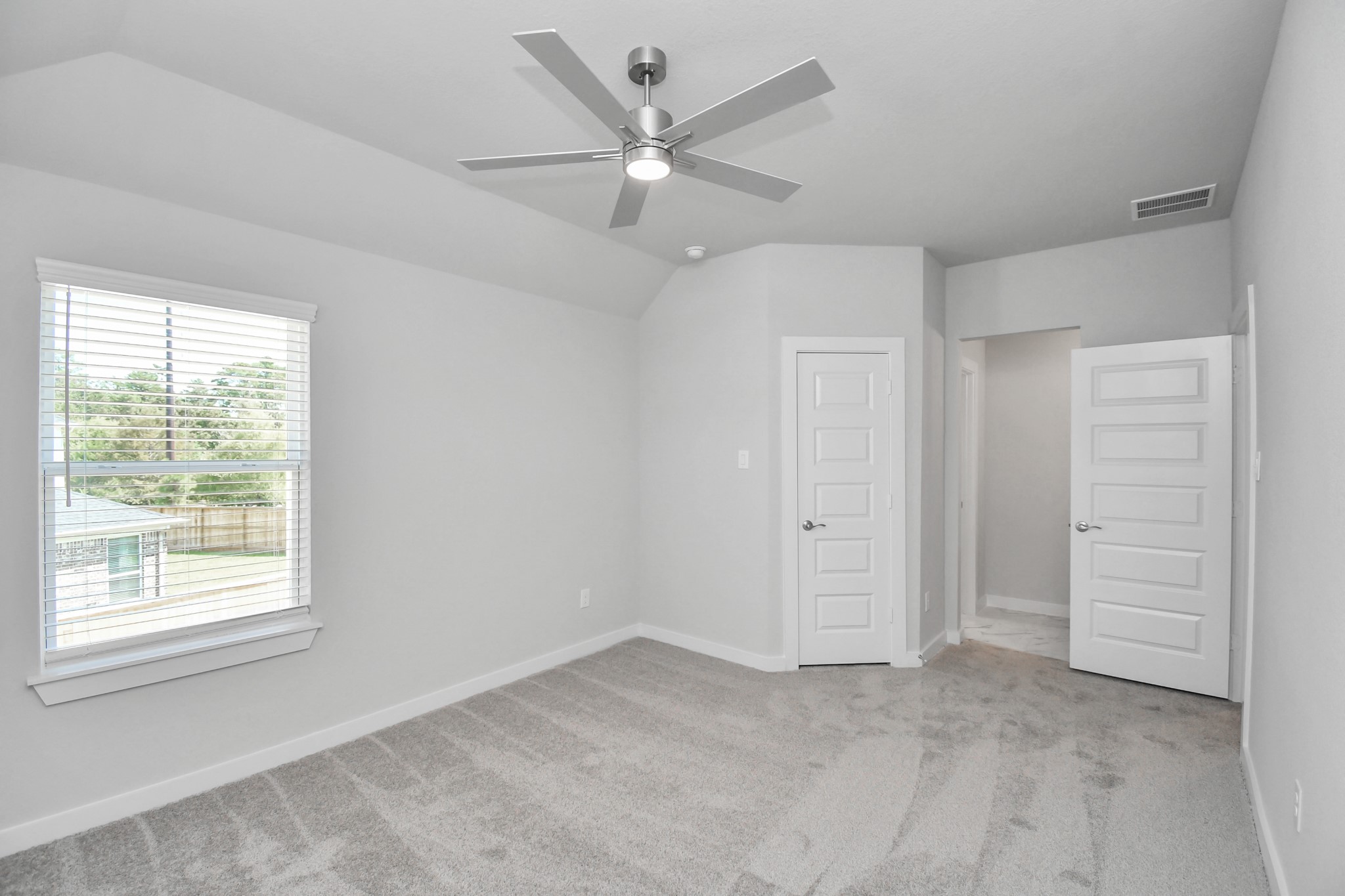Generously sized secondary bedrooms featuring spacious closets, soft and inviting carpeting underfoot, large windows allowing plenty of natural light, and the added touch of privacy blinds for your personal retreat. Sample photo of completed home with similar floor plan. Actual colors and selections may vary.