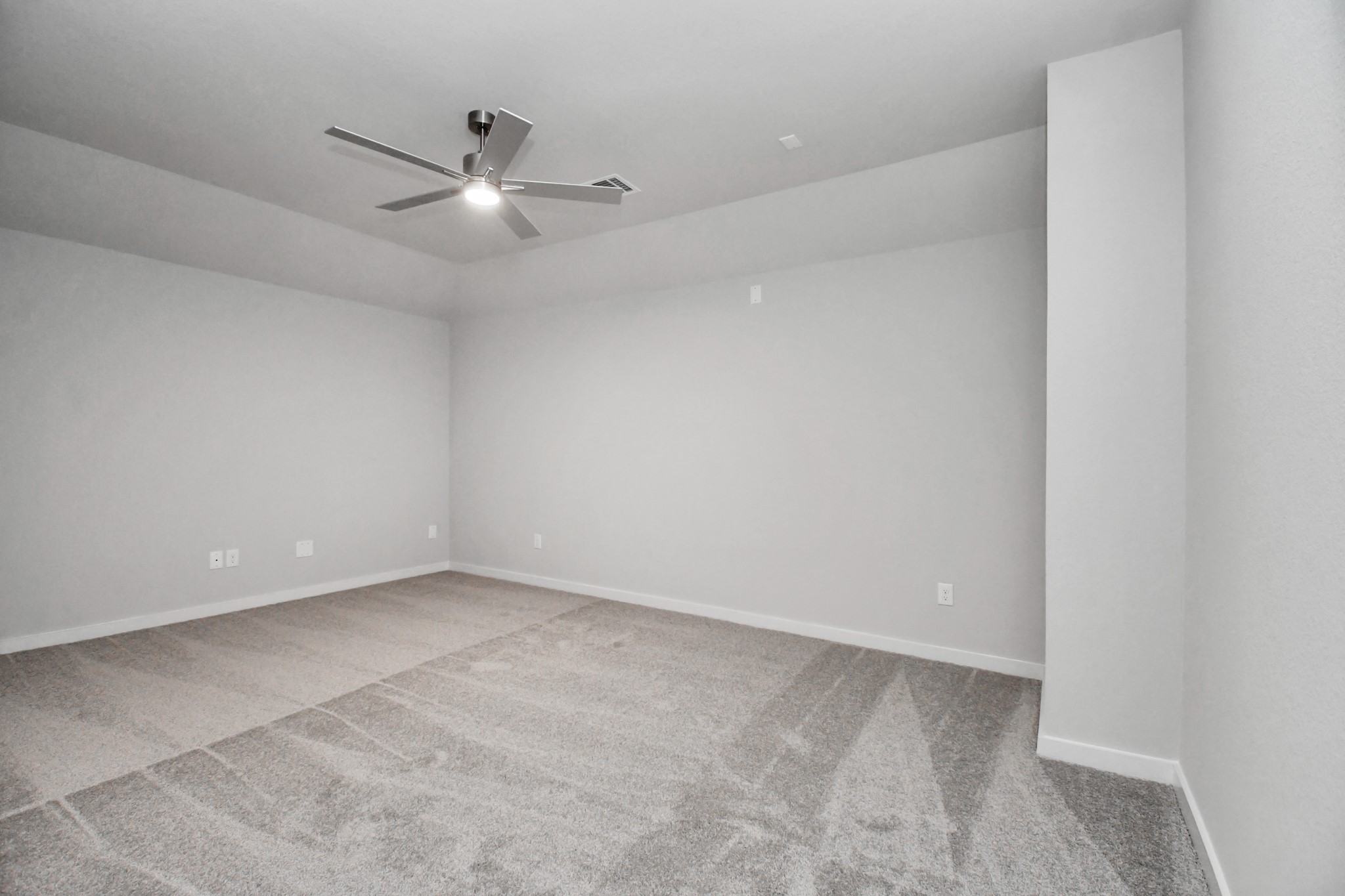Secondary bedroom features plush carpeting, large windows that let in plenty of natural light, bright paint, and spacious closets. Sample photo of completed home with similar floor plan. Actual colors and selections may vary.