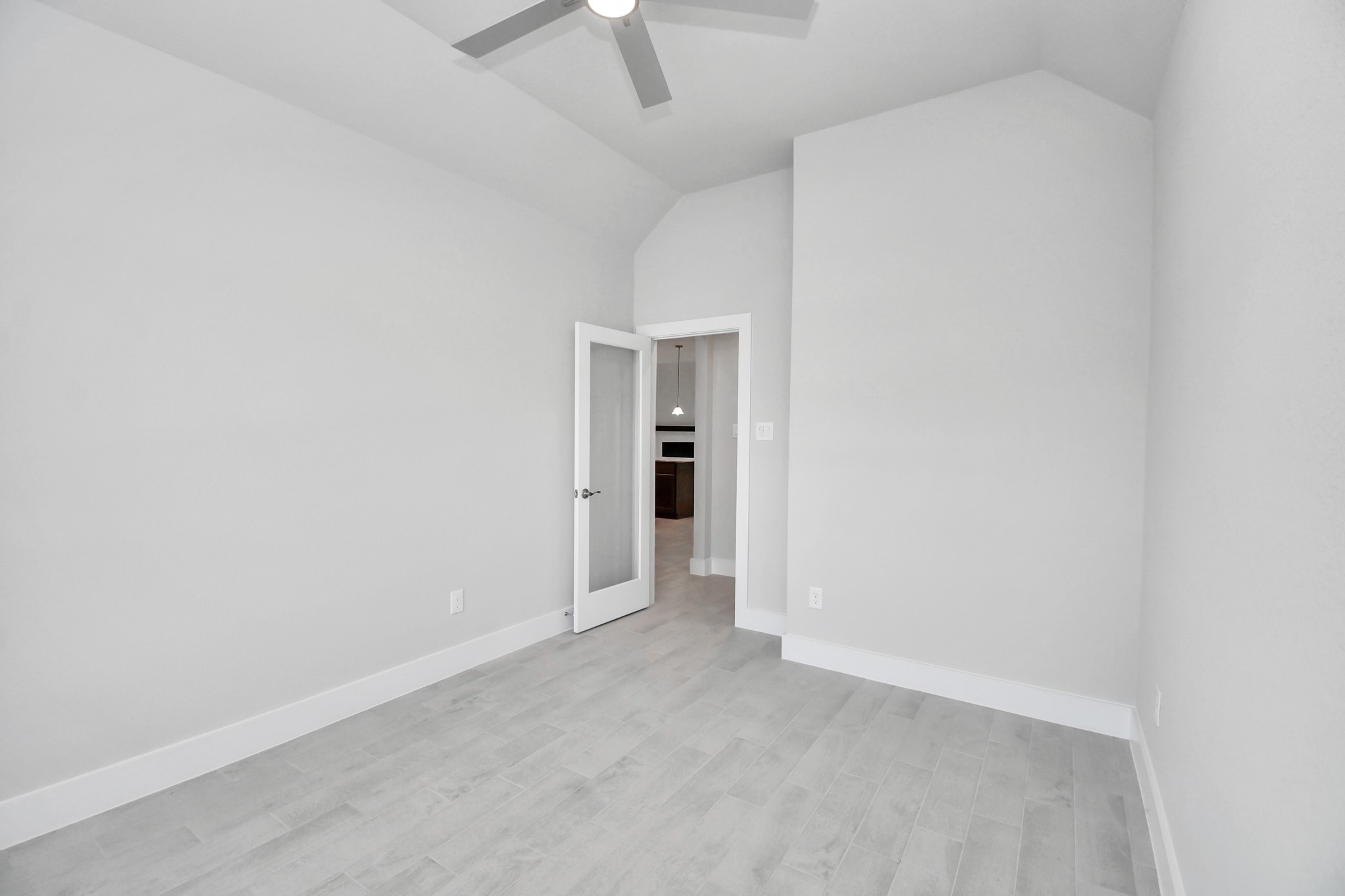 Step into the inviting home office, where elegant tile flooring adds a touch of freshness and comfort to the workspace. Natural light pours through the window, creating an inspiring environment for productivity and focus. Sample photo of completed home with similar floor plan. Actual colors and selections may vary.