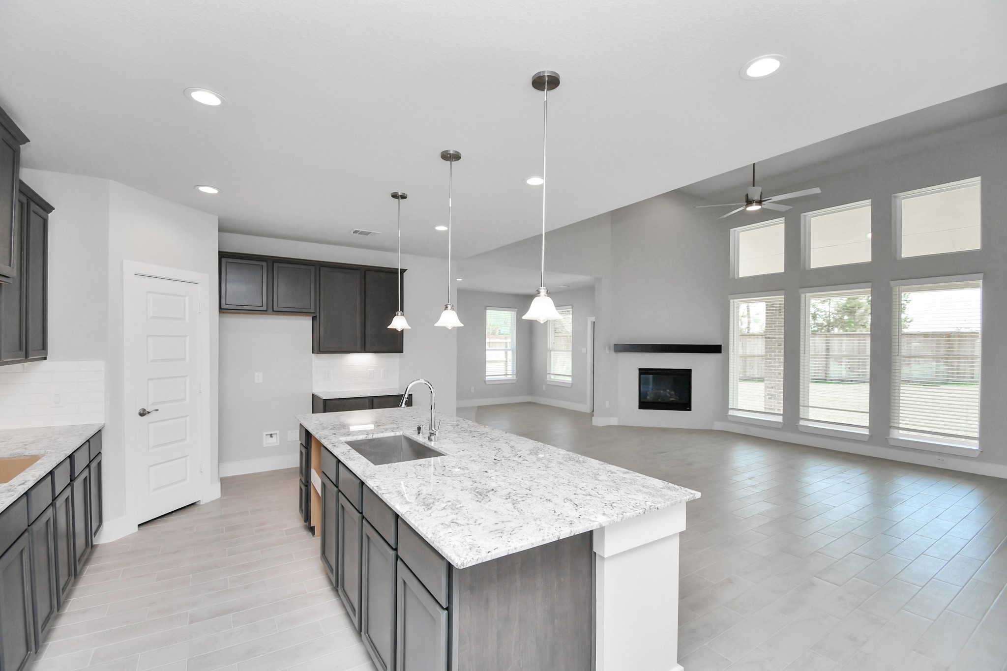 All of this overlooks your expansive family room, creating a perfect space for culinary delights and family gatherings. Sample photo of completed home with similar floor plan. Actual colors and selections may vary.
