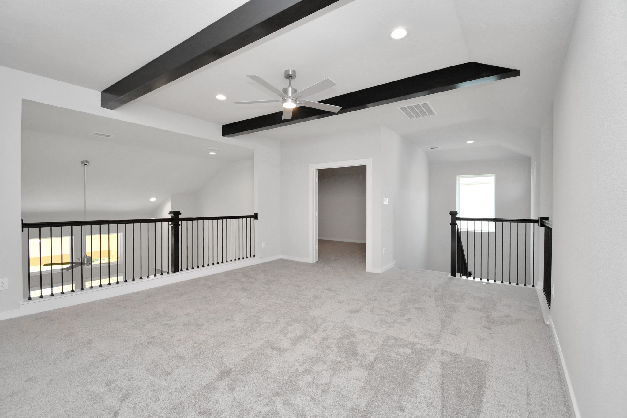 Discover a haven of leisure in this fantastic game room! Whether you're seeking a casual hangout or an adult gaming retreat, this space has it all. Enjoy the luxurious feel of plush carpet underfoot, the expansive ambiance of high ceilings, custom paint that adds a touch of personality, and windows that flood the room with refreshing natural light. Sample photo of completed home with similar floor plan. Actual colors and selections may vary.