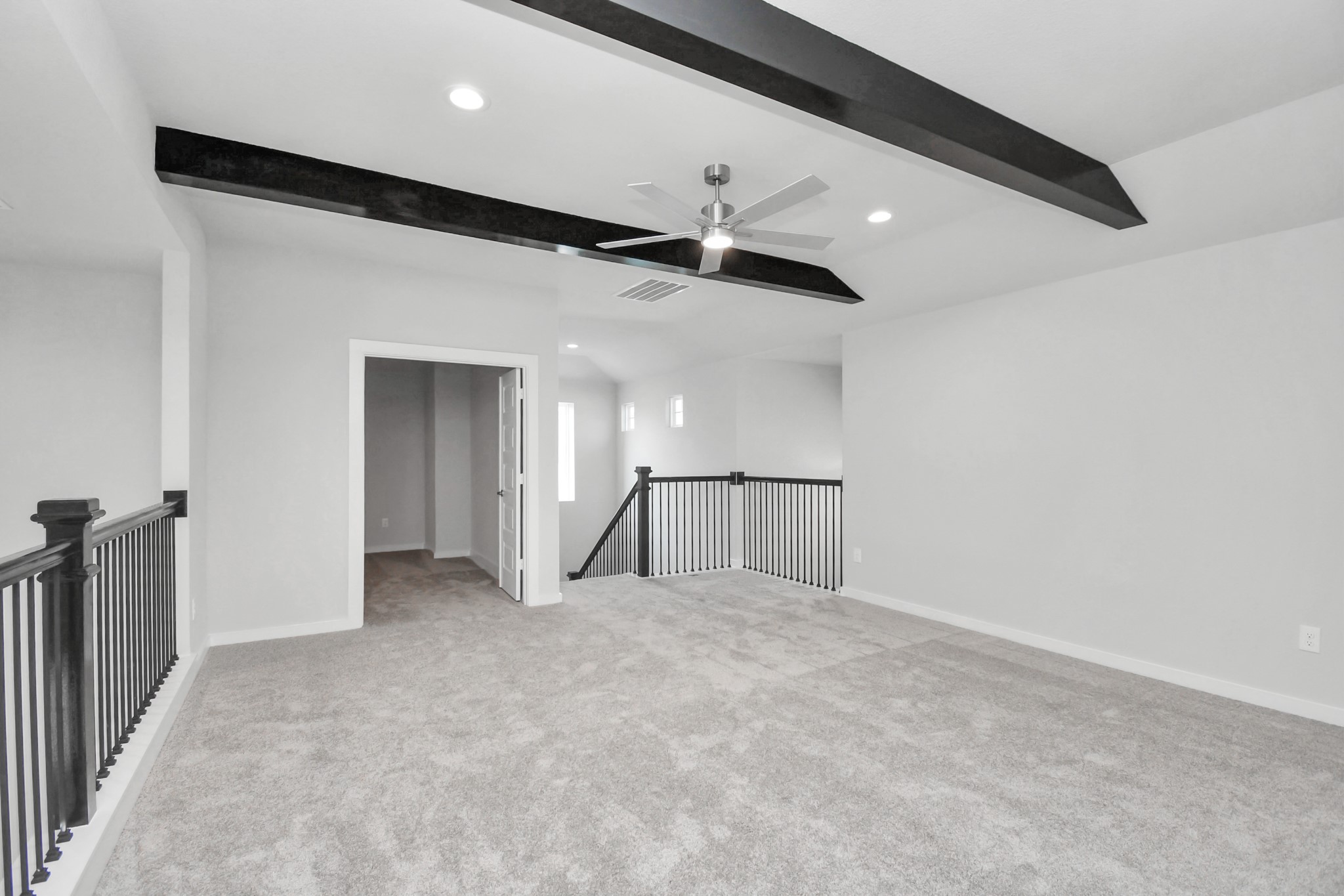 Ascend to relaxation in this fantastic game room! Ideal for both casual gatherings and adult gaming, it boasts plush carpet, lofty ceilings, custom paint, and ample windows for abundant natural light. Sample photo of completed home with similar floor plan. Actual colors and selections may vary.