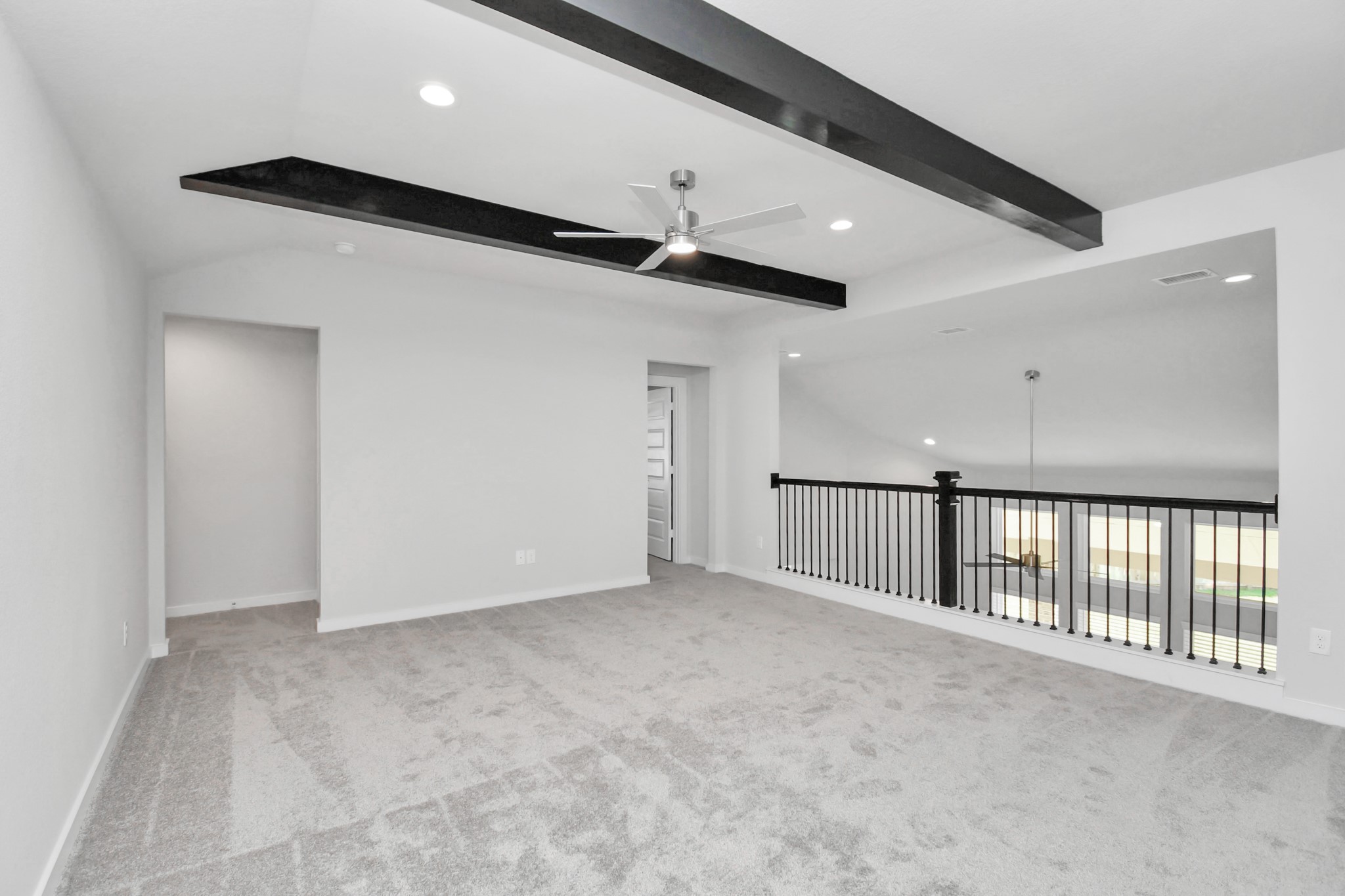 Come upstairs and enjoy a day of leisure in this fabulous game room! This is the perfect hangout spot or adult game room! Features plush carpet, high ceilings, custom paint and windows for plenty of natural light. Sample photo of completed home with similar floor plan. Actual colors and selections may vary.