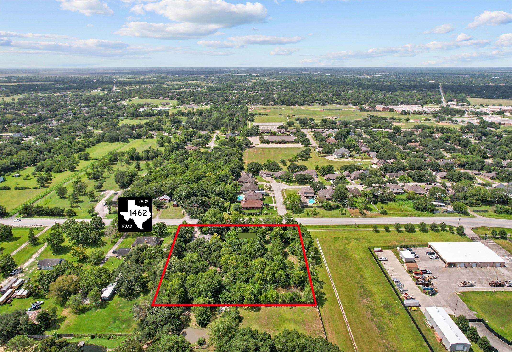 Expansive wooded lot outlined in red, offering privacy and potential, conveniently located acess to FM 1462.