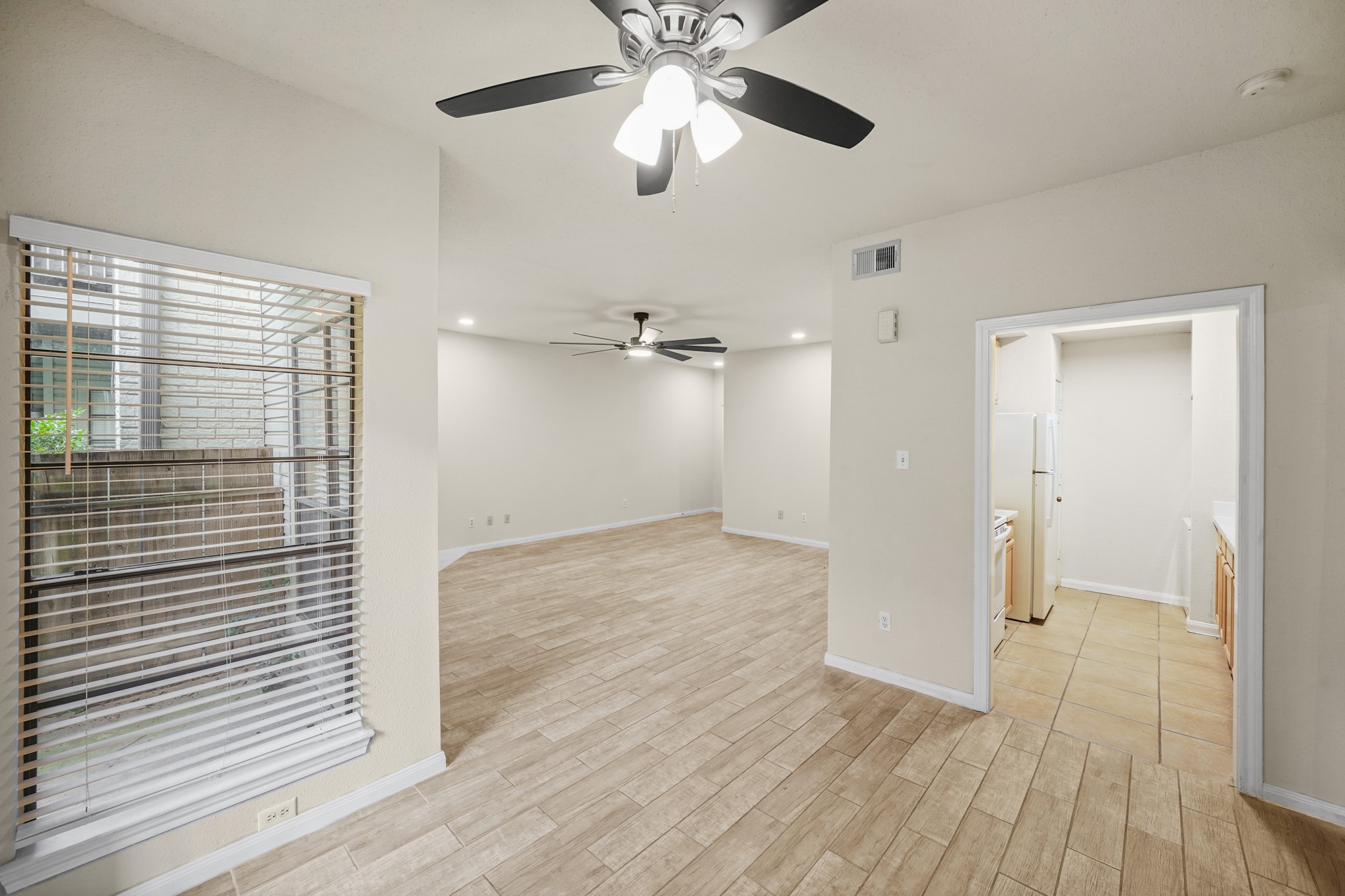 View of the living area and entrance way to the kitchen from the dining area.