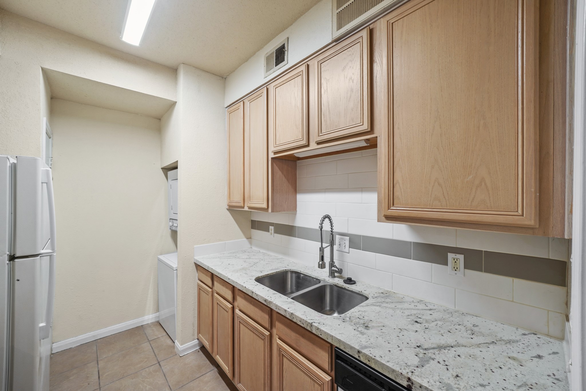 This home features a convenient laundry area with a washer and dryer right next to the kitchen.