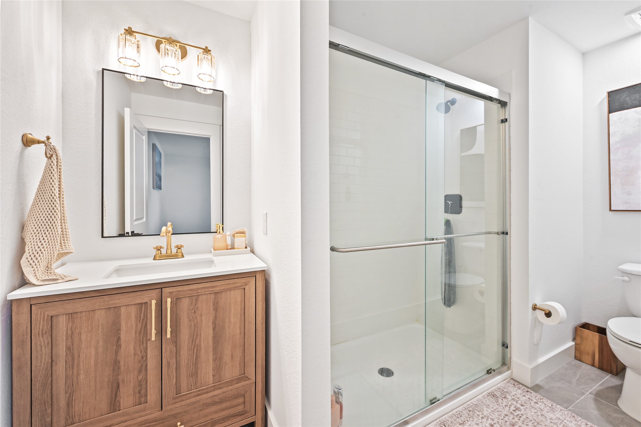 glass-enclosed walk-in shower with contemporary fixtures and beautiful tilework