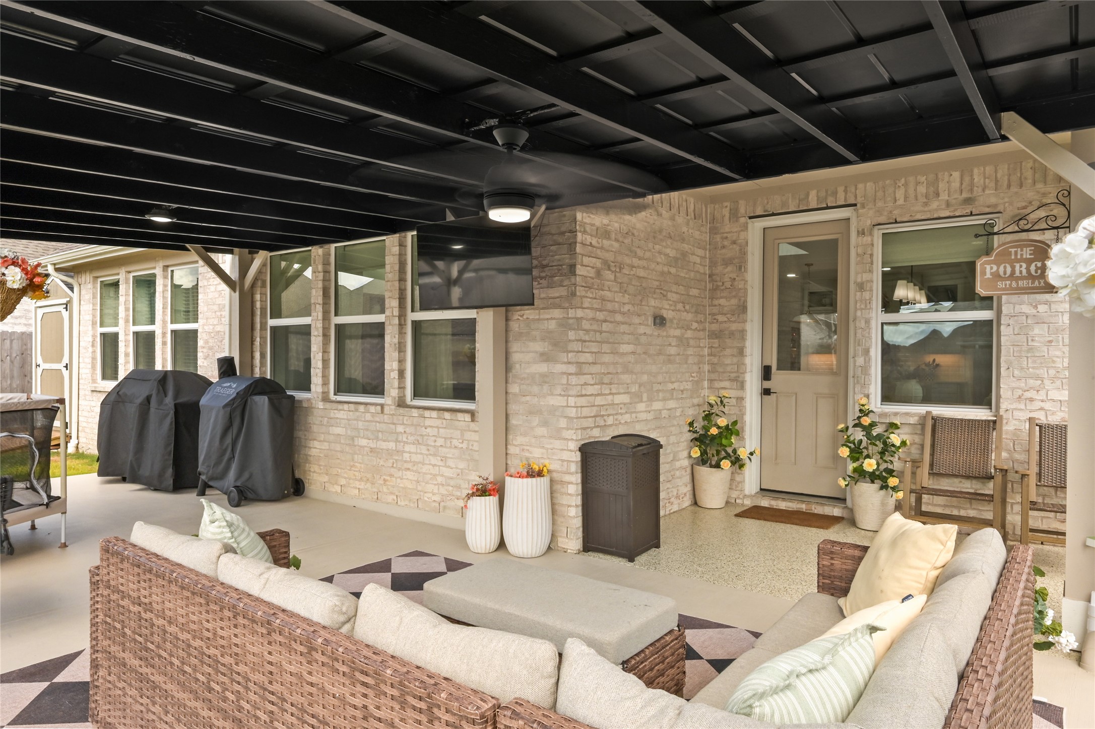 welcoming space for outdoor dining, relaxing, or hosting gatherings while enjoying views of the backyard.
