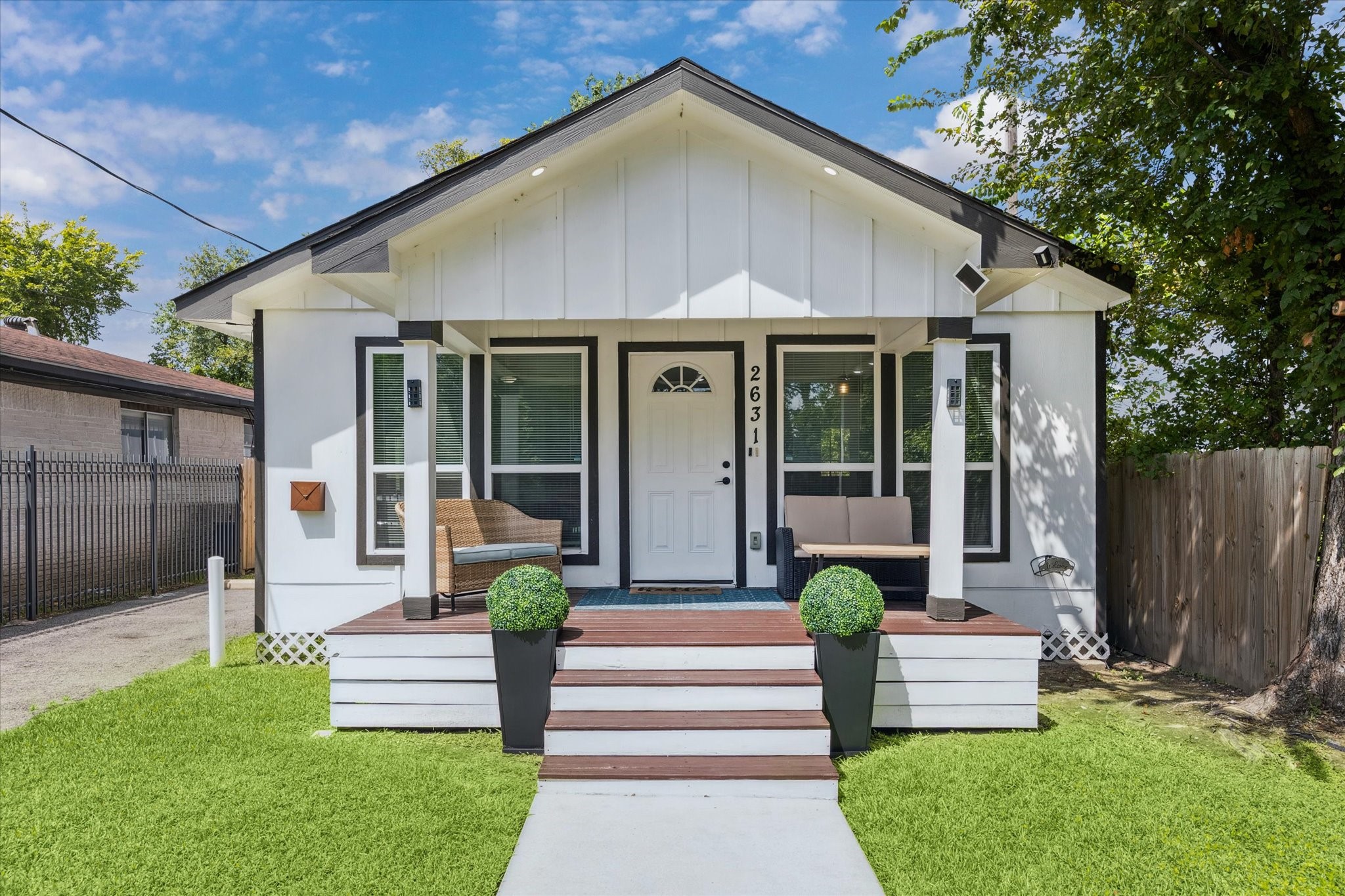 Freshly painted and full of charm, this modern bungalow features a classic black-and-white exterior and a cozy covered front porchperfect for morning coffee or winding down in the evening. Clean lines and updated finishes give it a crisp, stylish look from the moment you walk up.