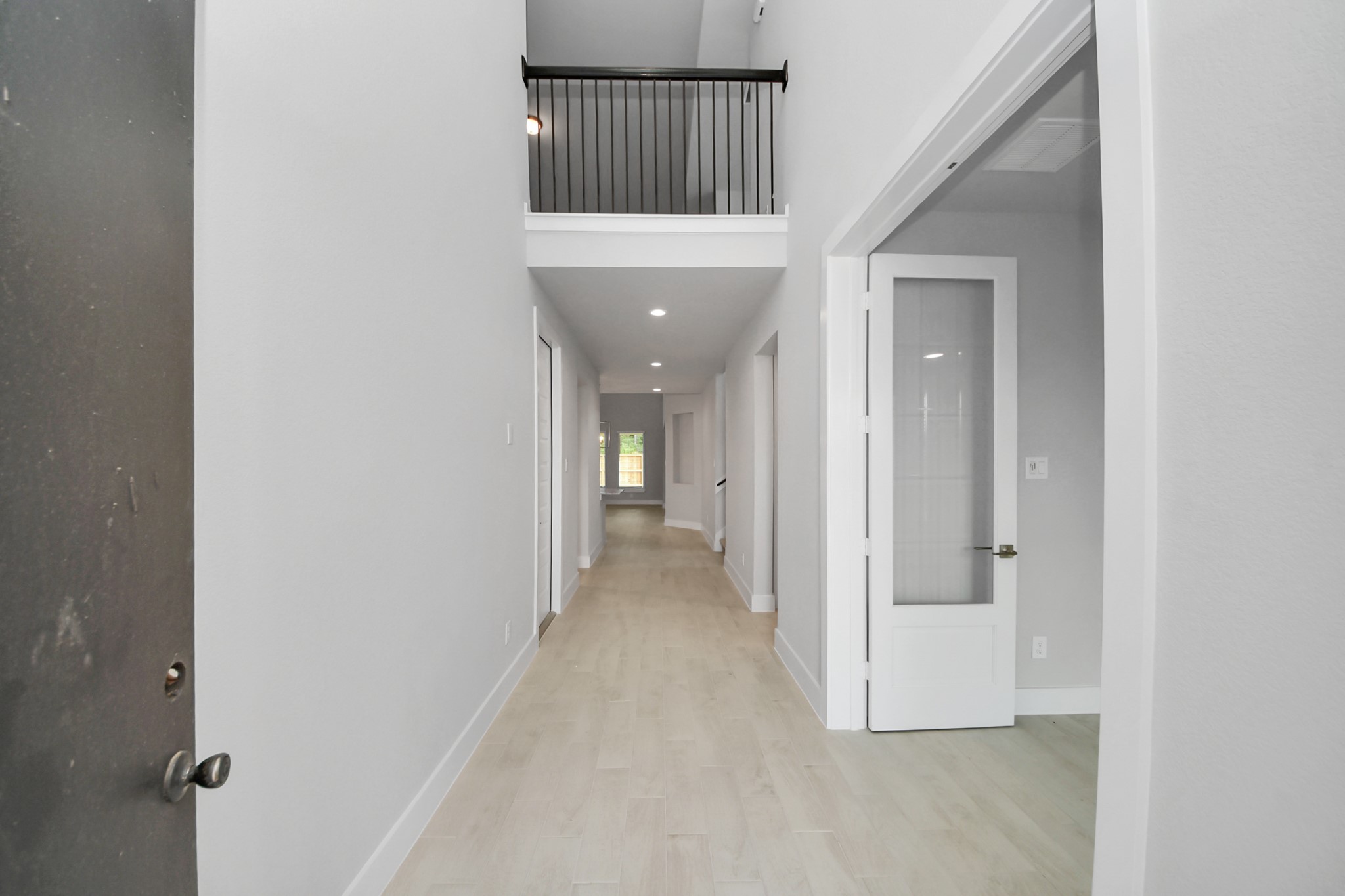 As you step into the threshold of this luxurious home, you'll soon be welcomed by an elegant glass door (to be installed). Inside, soaring ceilings amplify the spaciousness, while the refined wood-look tile flooring and oversized baseboards exude sophistication and charm. Sample photo of completed home with similar floor plan. Actual colors and selections may vary.